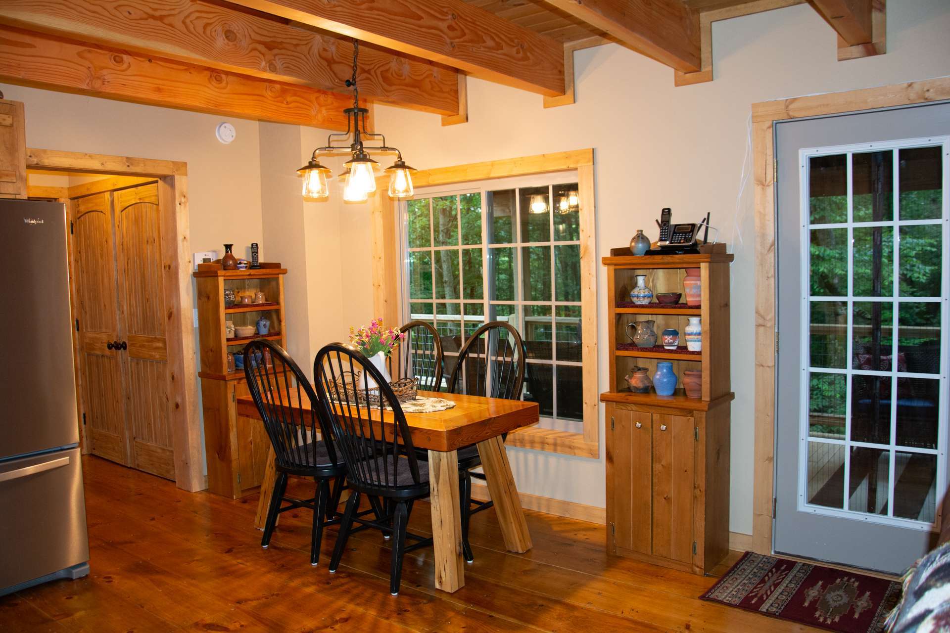 Open to the kitchen and living areas, the dining area allows you to enjoy the outdoor scenery while dining inside.