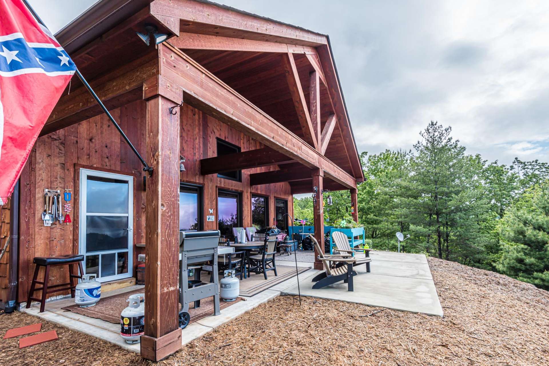 This vaulted covered porch offers plenty of space for outdoor grilling, dining, and entertaining.