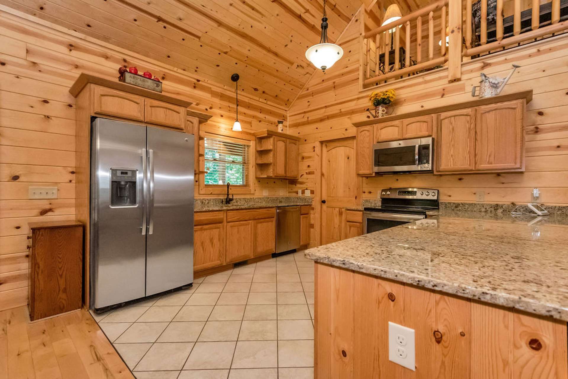 The kitchen features granite countertops, stainless appliances, and an oversized eating bar. You can have a workspace while your guests enjoy their favorite beverages and appetizers.