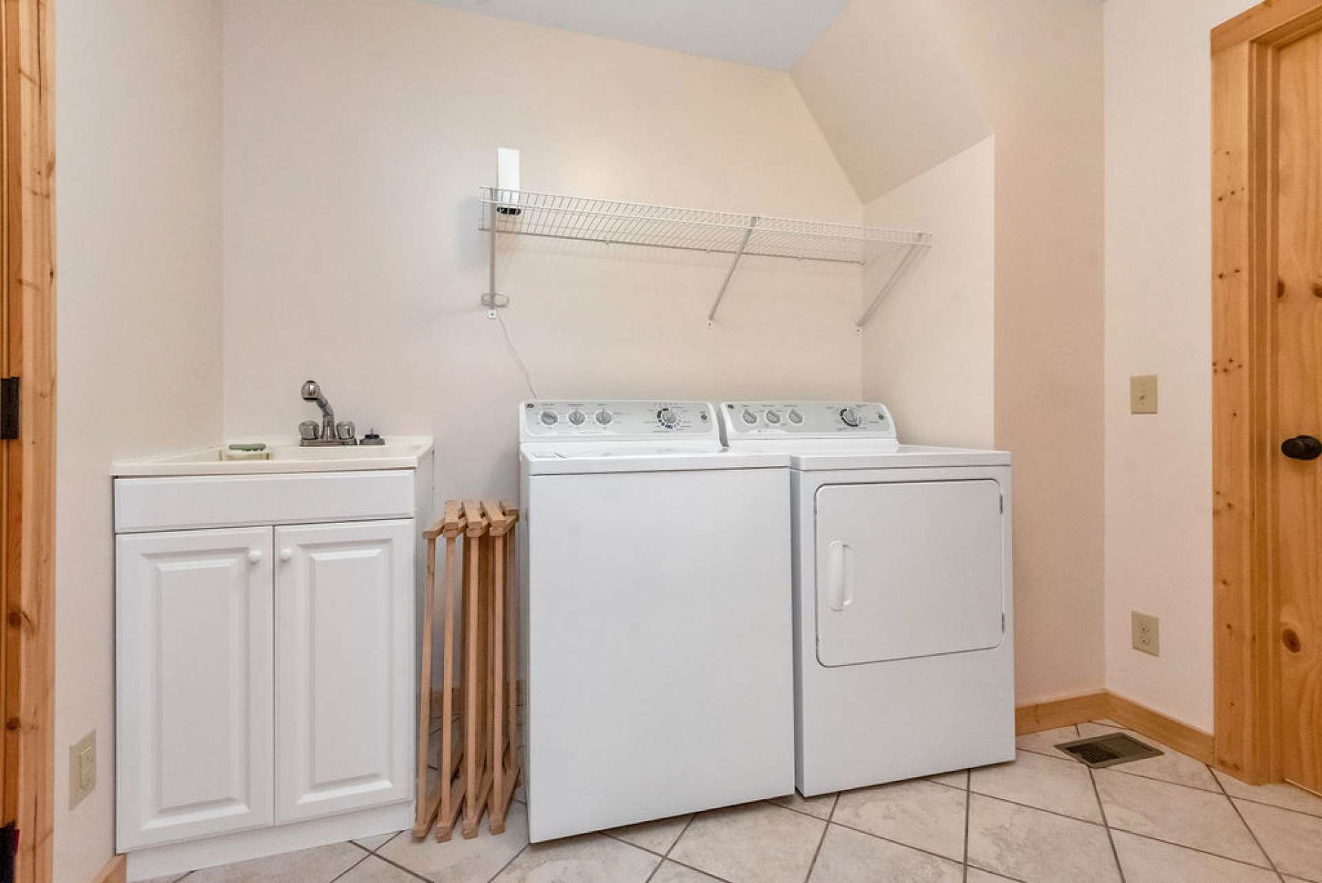 Laundry offers sink, coat closet, and a pantry. There is access to the back deck from here, as well.