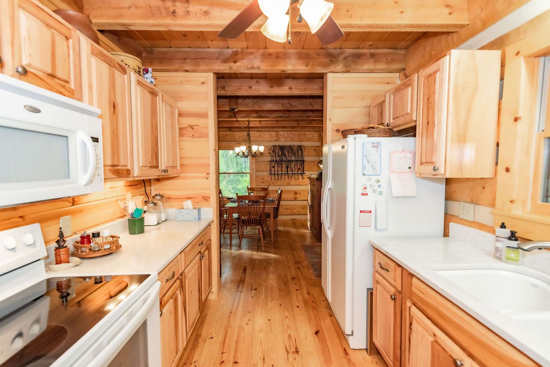 The galley style kitchen offers custom cabinetry with ample work and storage space.