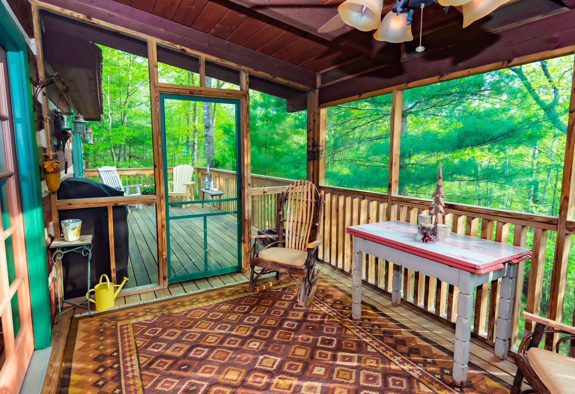 The screened in porch area is perfect for outdoor dining and expands the living space during the warmer months.