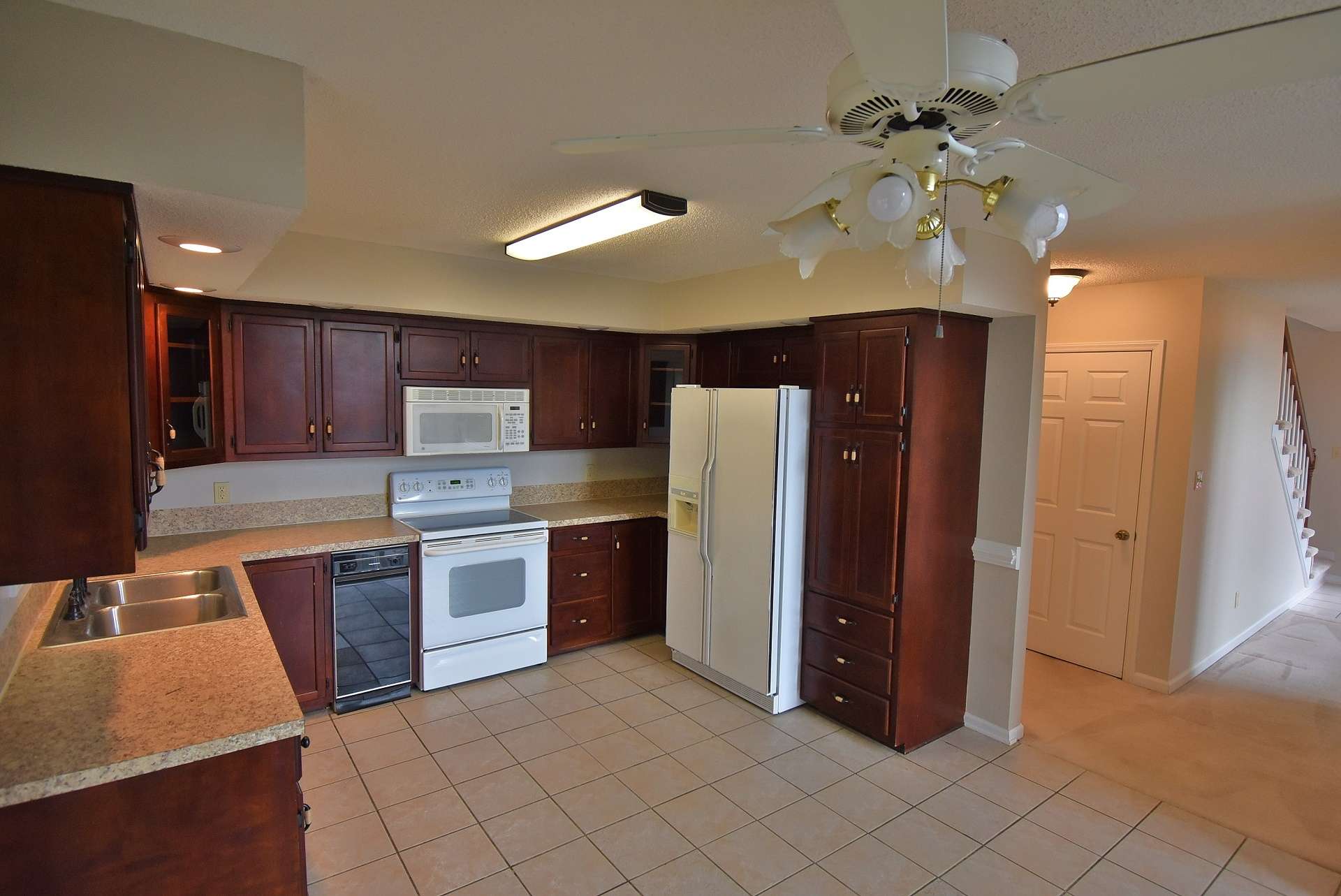 This spacious kitchen features ceramic tiled floor and offers plenty of work and storage space.