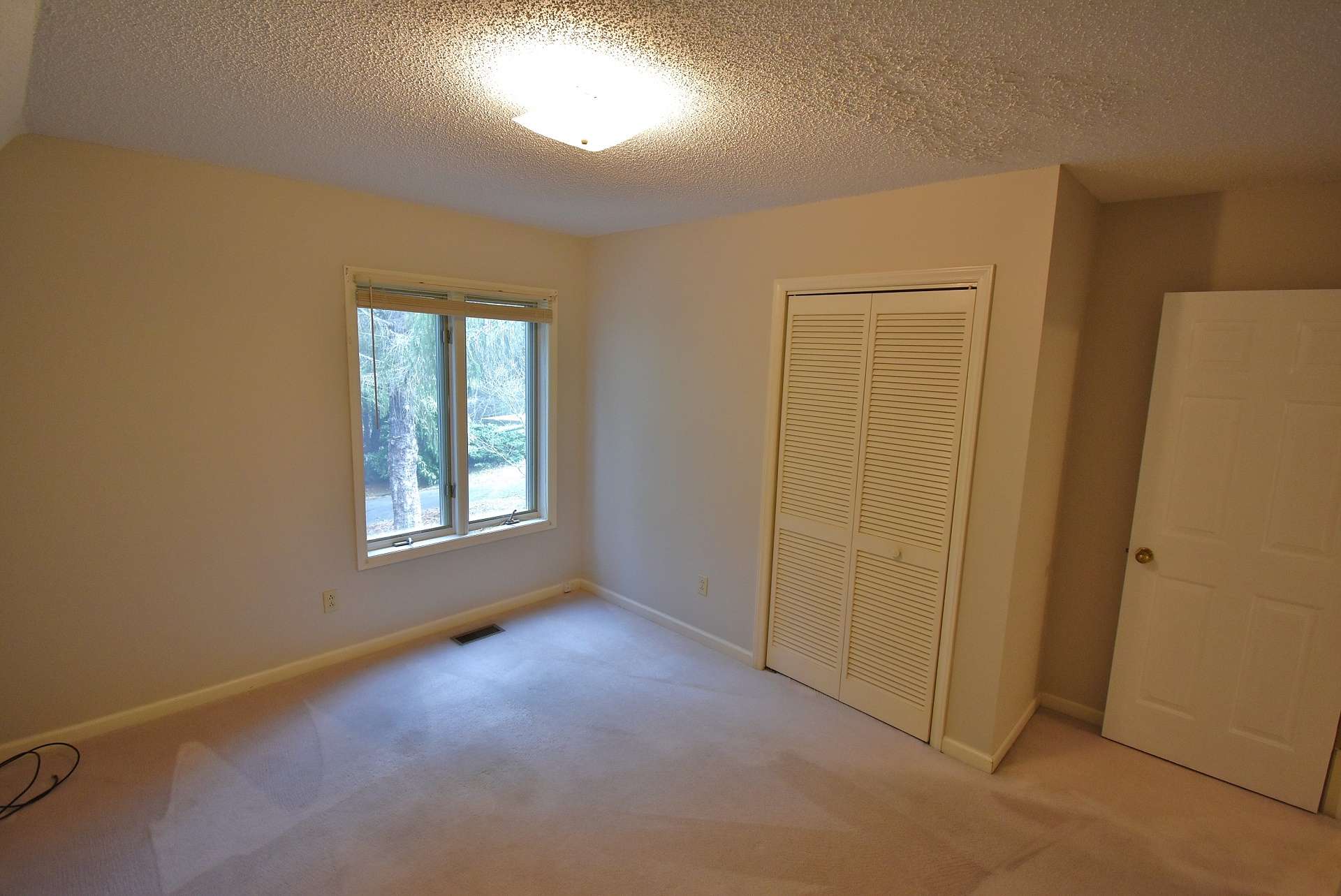 The two main level guest bedrooms are both spacious, light filled, and offer comfortable carpeted flooring.