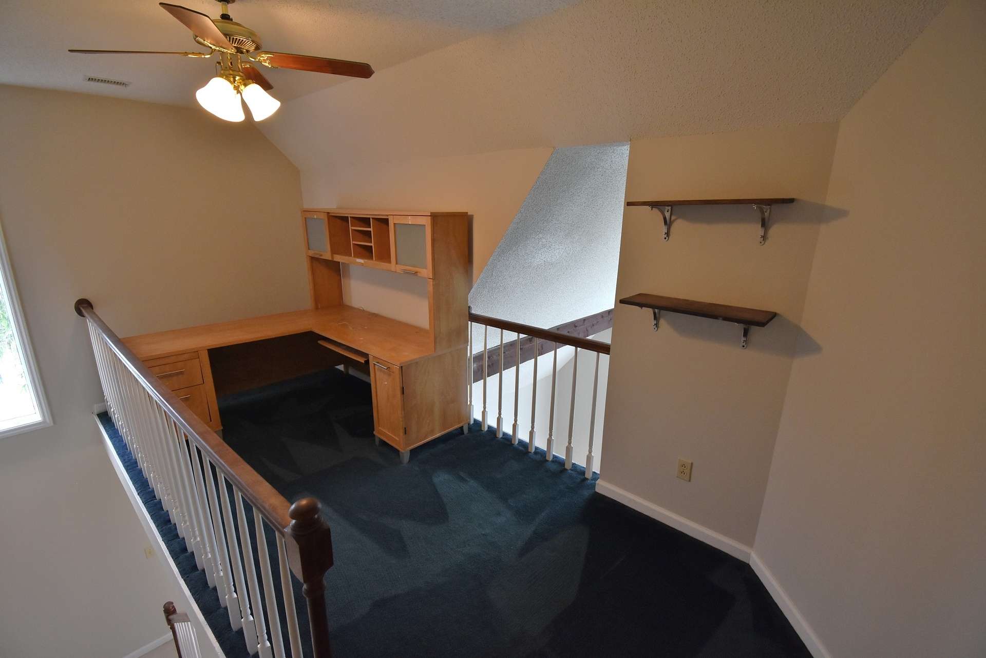 The upper level offers this loft area overlooking the living room.  This would be a great space to utilize as an office area or library.