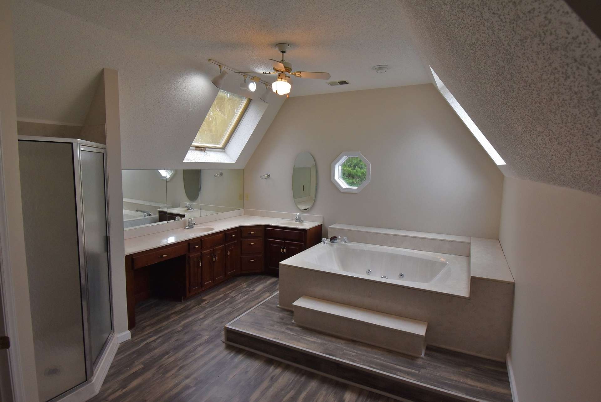 Enjoy a spa-like experience in the master bath with long double vanity, skylights, jetted tub and walk-in shower.