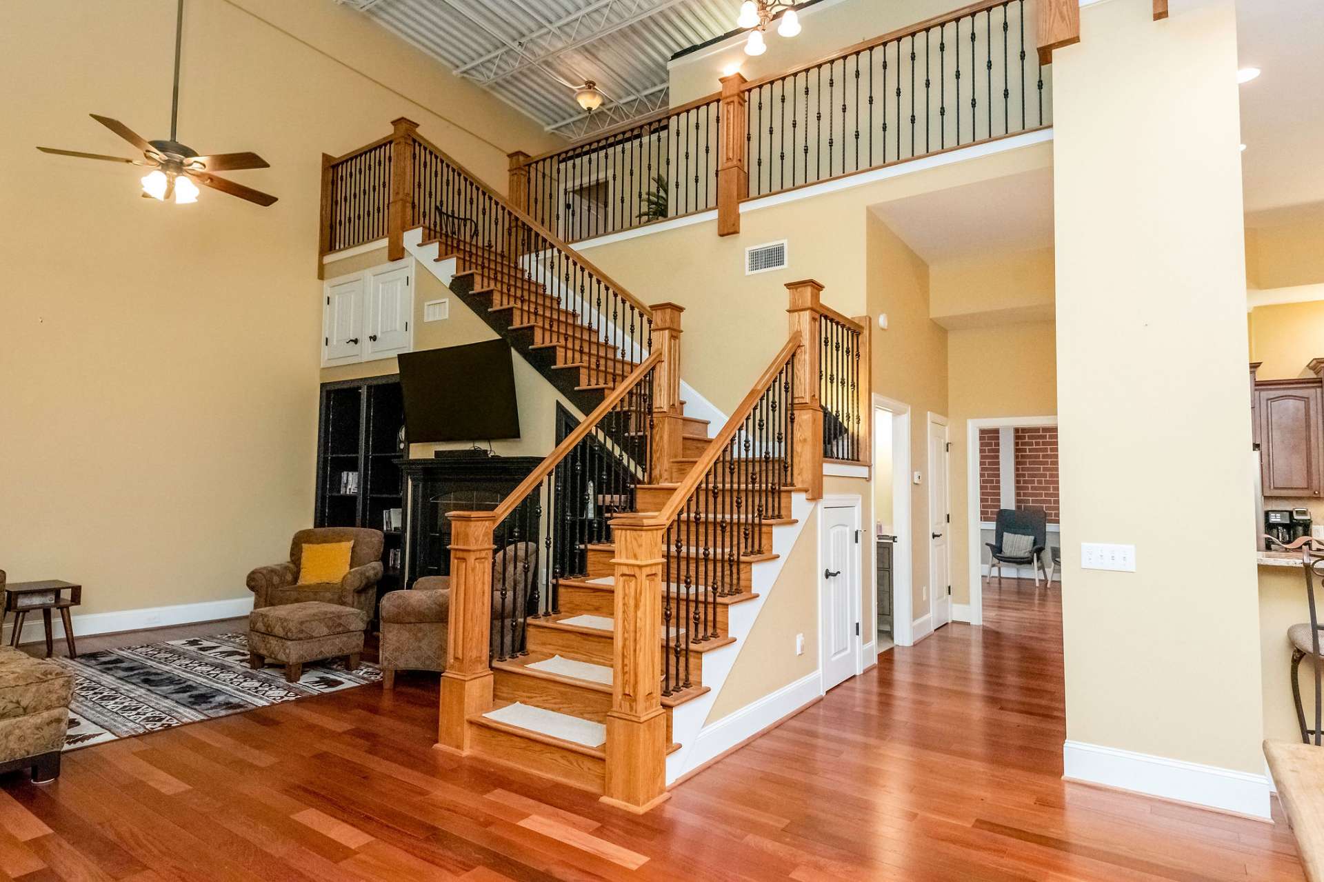 This grand staircase takes you to the spacious upper level. All rooms flow together with Brazilian cherry hardwood flooring and soaring ceilings.