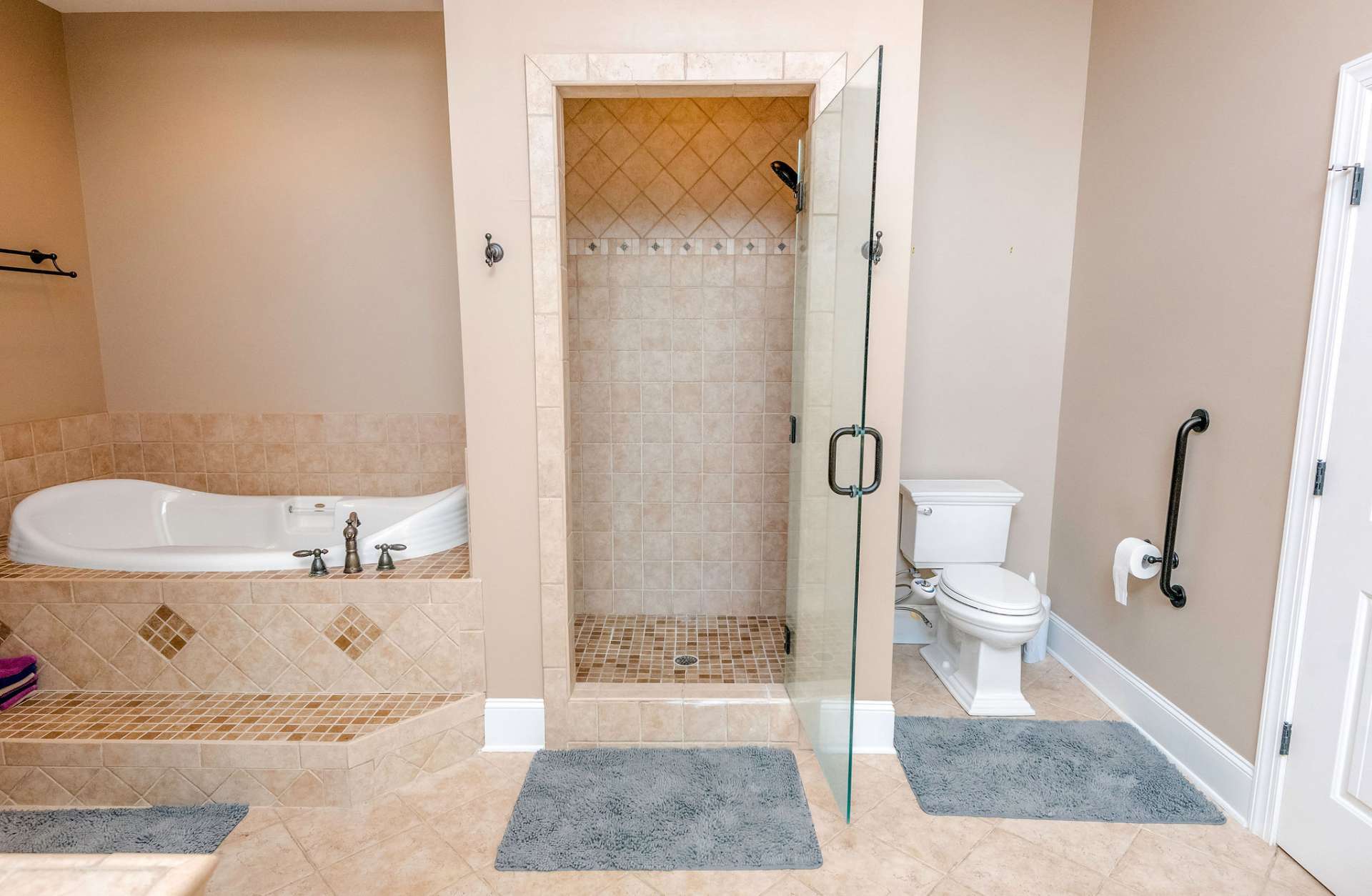 Master bath offers soaking tub, tile shower and private toilet area.