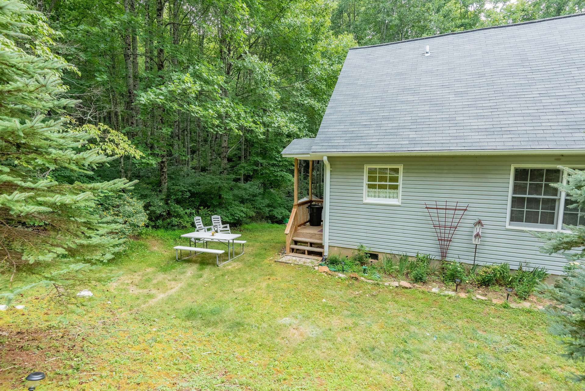 Enjoy a picnic lunch in the spacious yard providing tons of room for gardening, outdoor activities, or for the dogs to play.