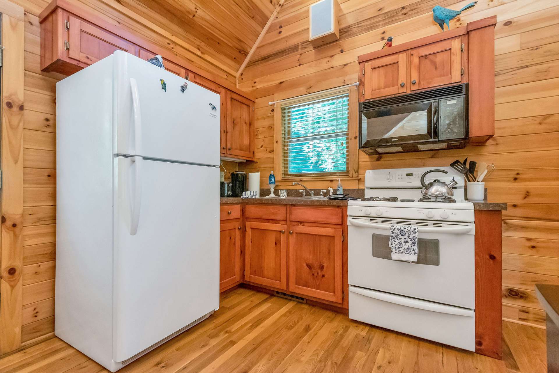 The cute kitchen offers a gas range and is perfect for making your favorite dinner.