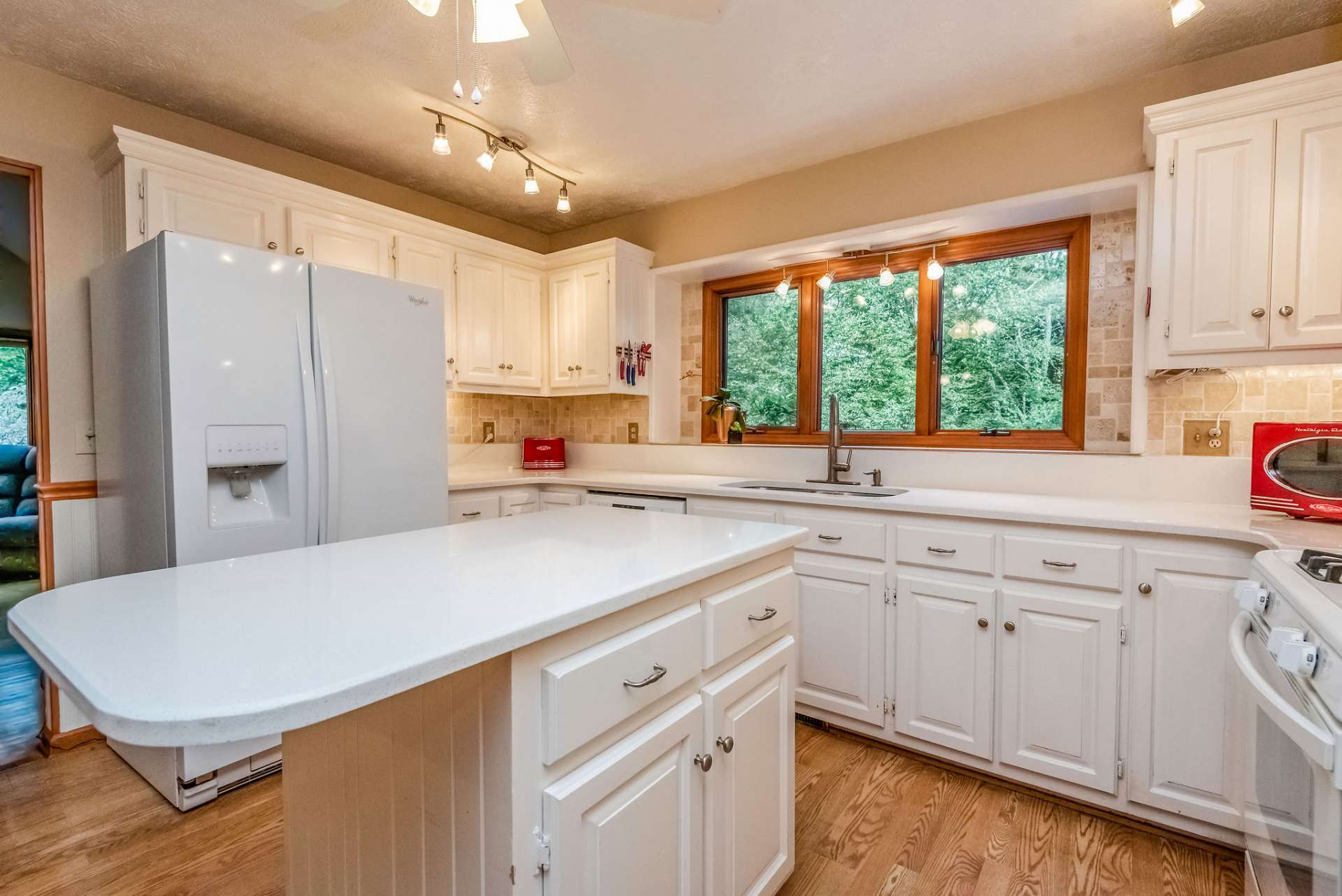 Sellers updated counter tops, appliances, and lighting in kitchen after purchasing the home.