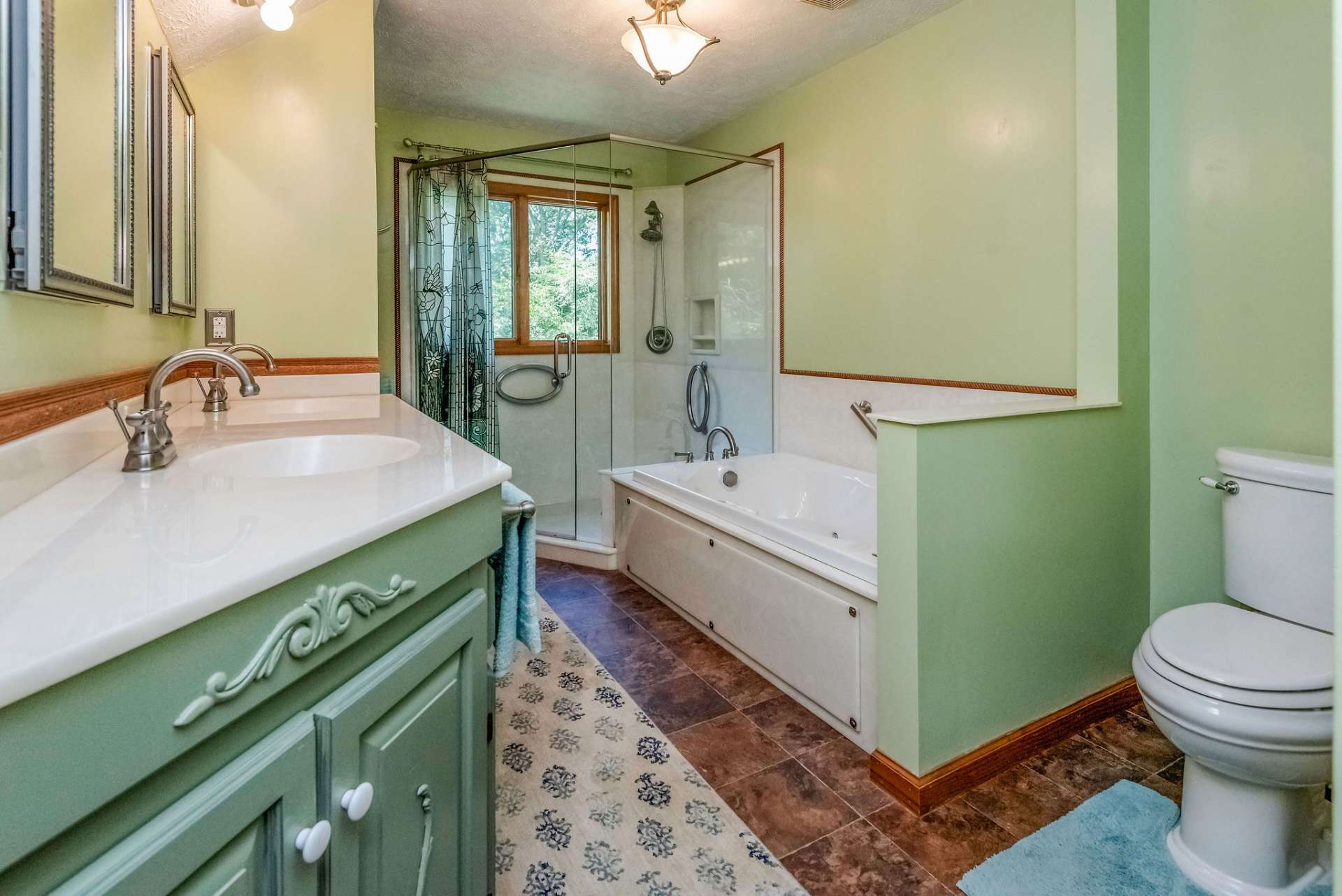 Walk in corner shower with seating.