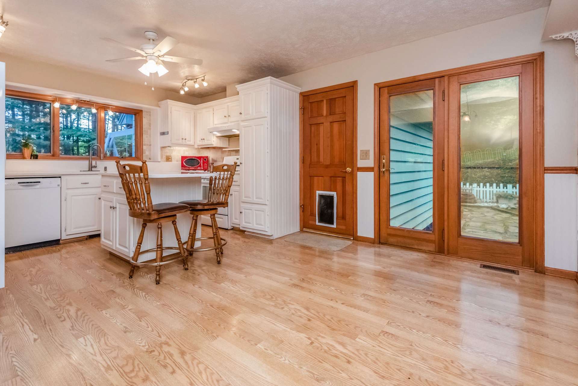 Spacious kitchen and dining area with french doors leading to the back yard and entry to/from the garage.