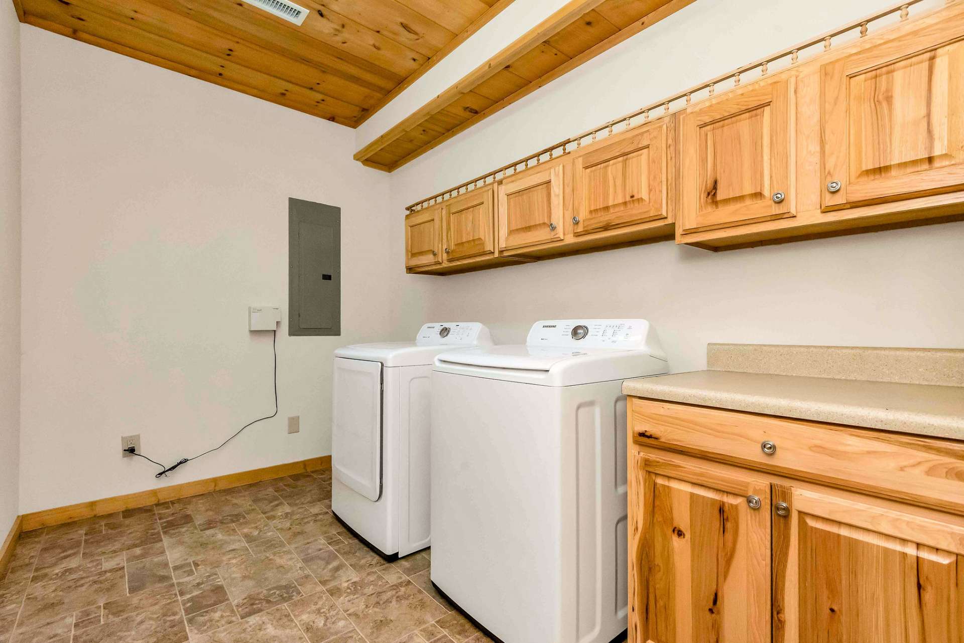 Laundry room with folding area and extra storage.