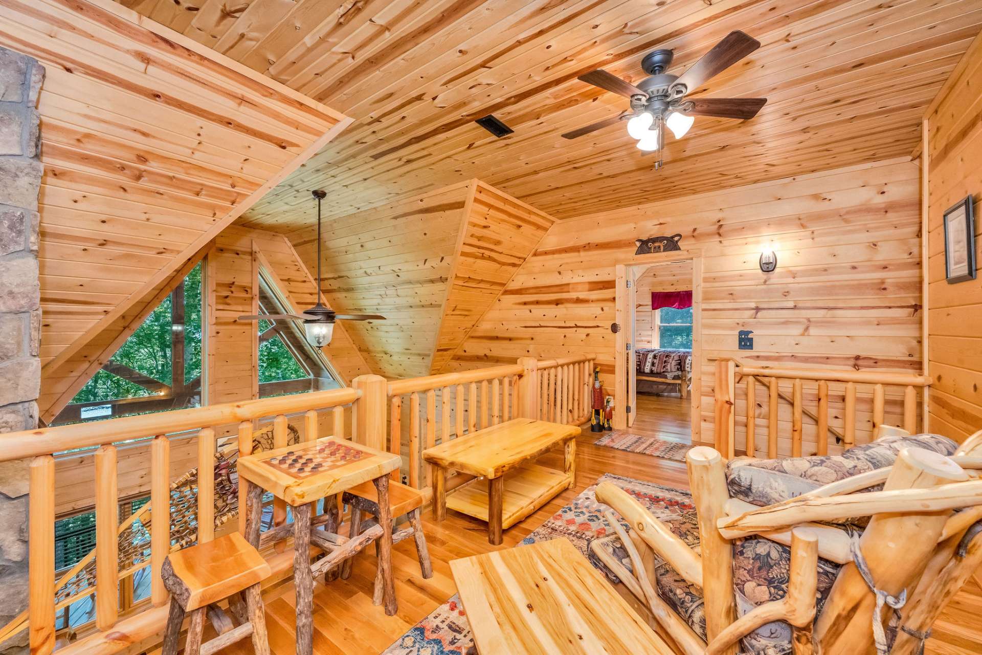 This airy loft lounge creates a peaceful perch above the great room—ideal for quiet moments or flexible use.