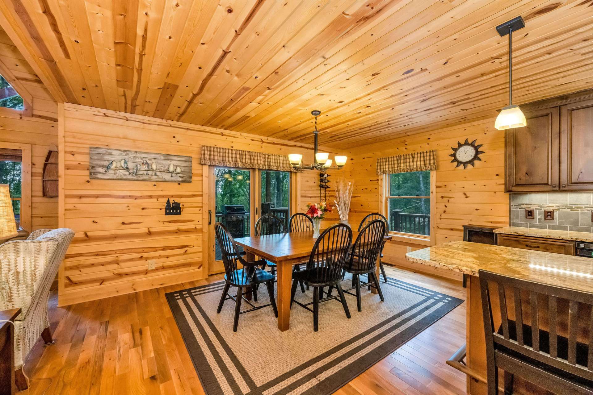 Dine indoors or out with ease—the dining area leads directly to a spacious covered deck surrounded by seasonal mountain views.