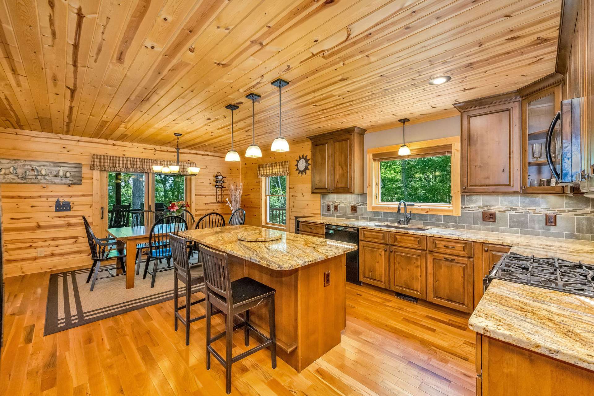 The granite surfaces and artisan tile backsplash work together to create a rich, layered look.