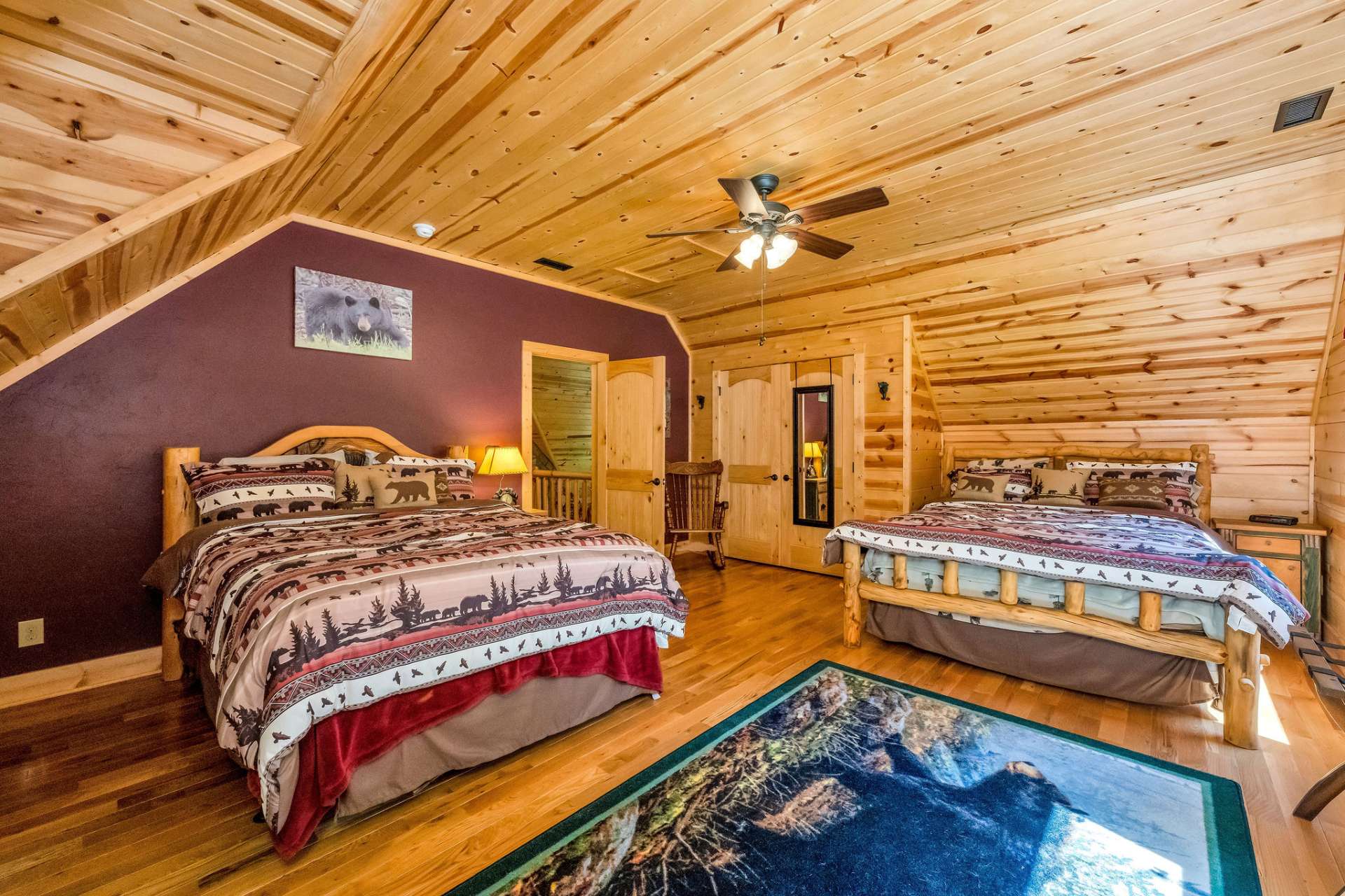 A large upstairs bedroom offers comfort, storage, and charm with a roomy closet and custom built-in cabinets.