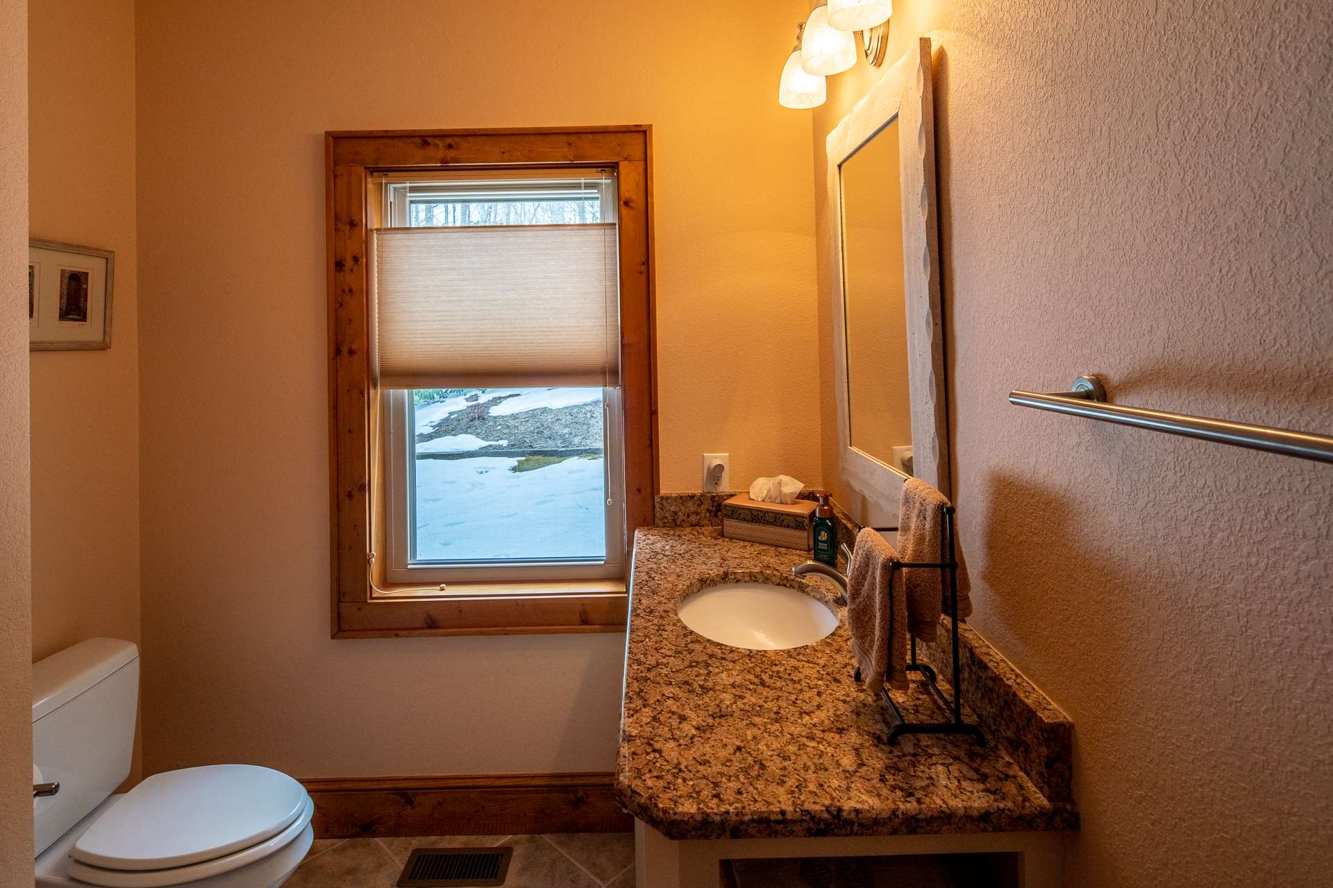 Powder room conveniently located in hallway adjacent to great room.