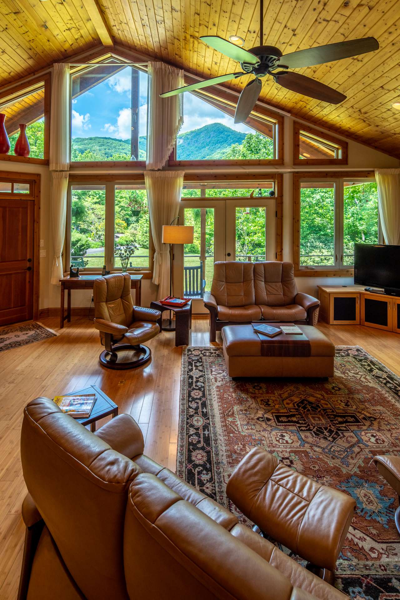 The front wall of windows bring in nature’s beauty and a stunning view of Bluff Mountain, including the waterfall periodically, which is owned by The Nature Conservancy.