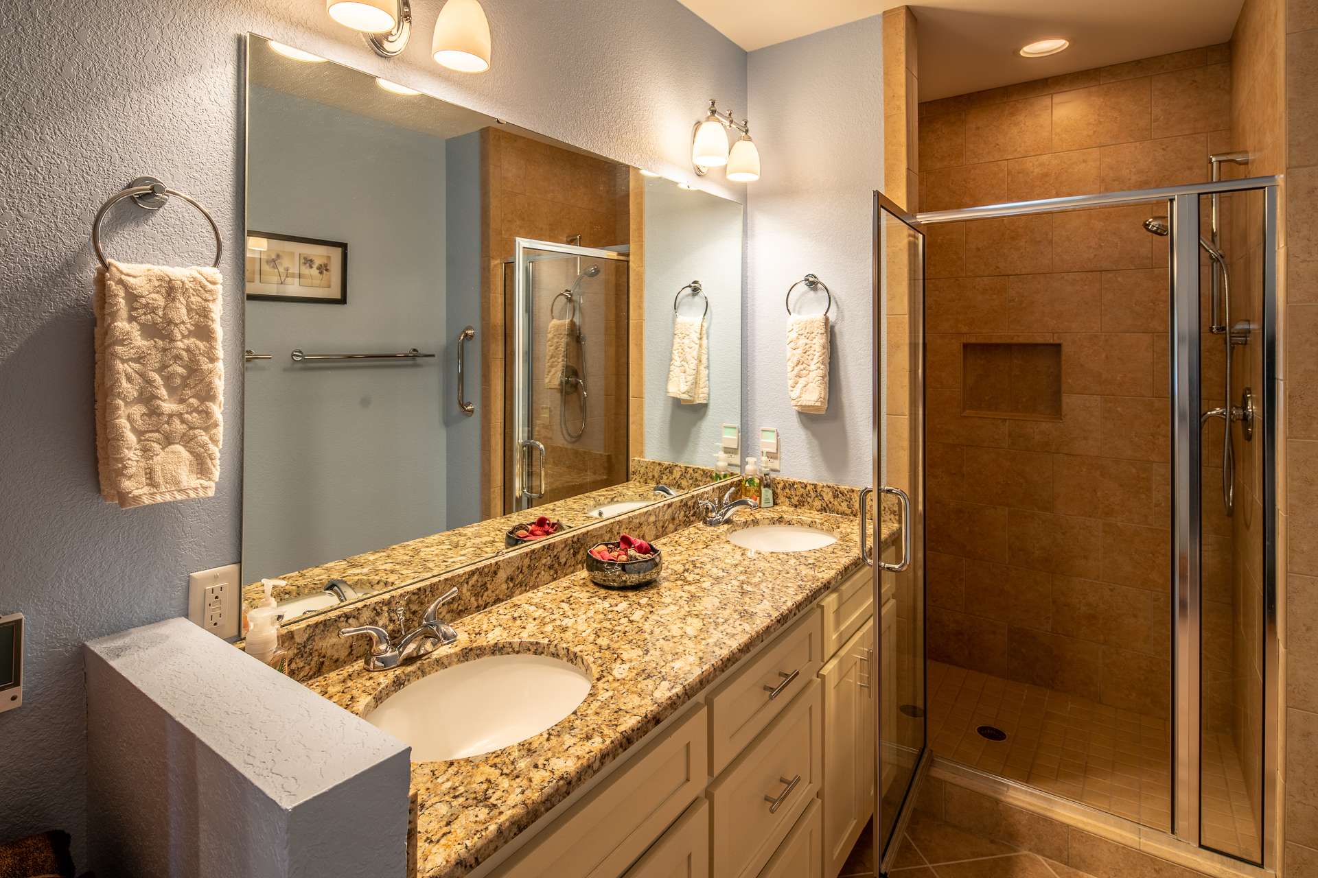 Private bath features double vanity, granite counter top, walk-in tile shower and heated tile floor.