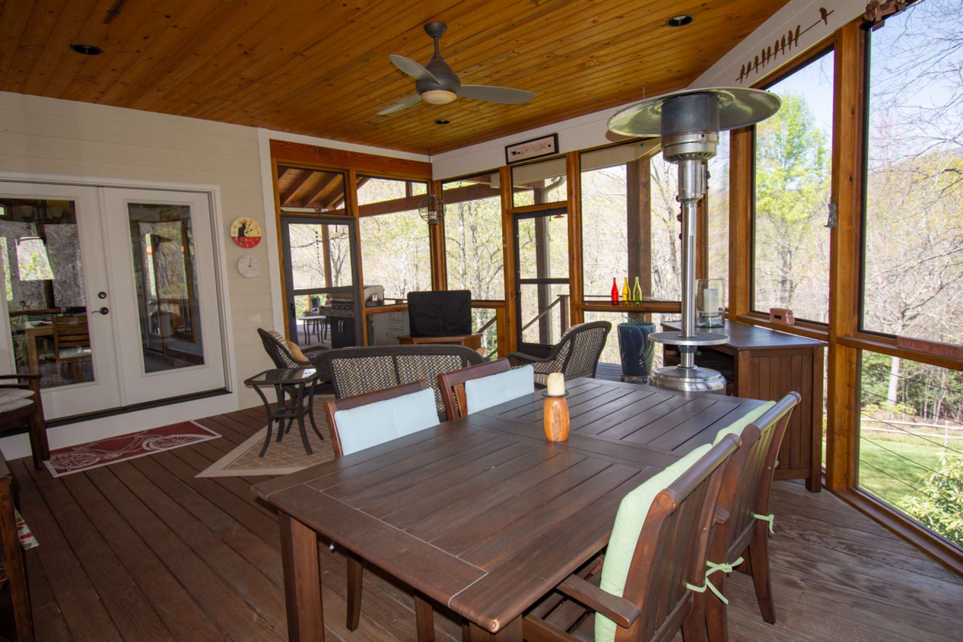 Screened porch, accessed from either dining area, master bedroom or covered deck, overlooks picturesque setting of lawn and mountains beyond.