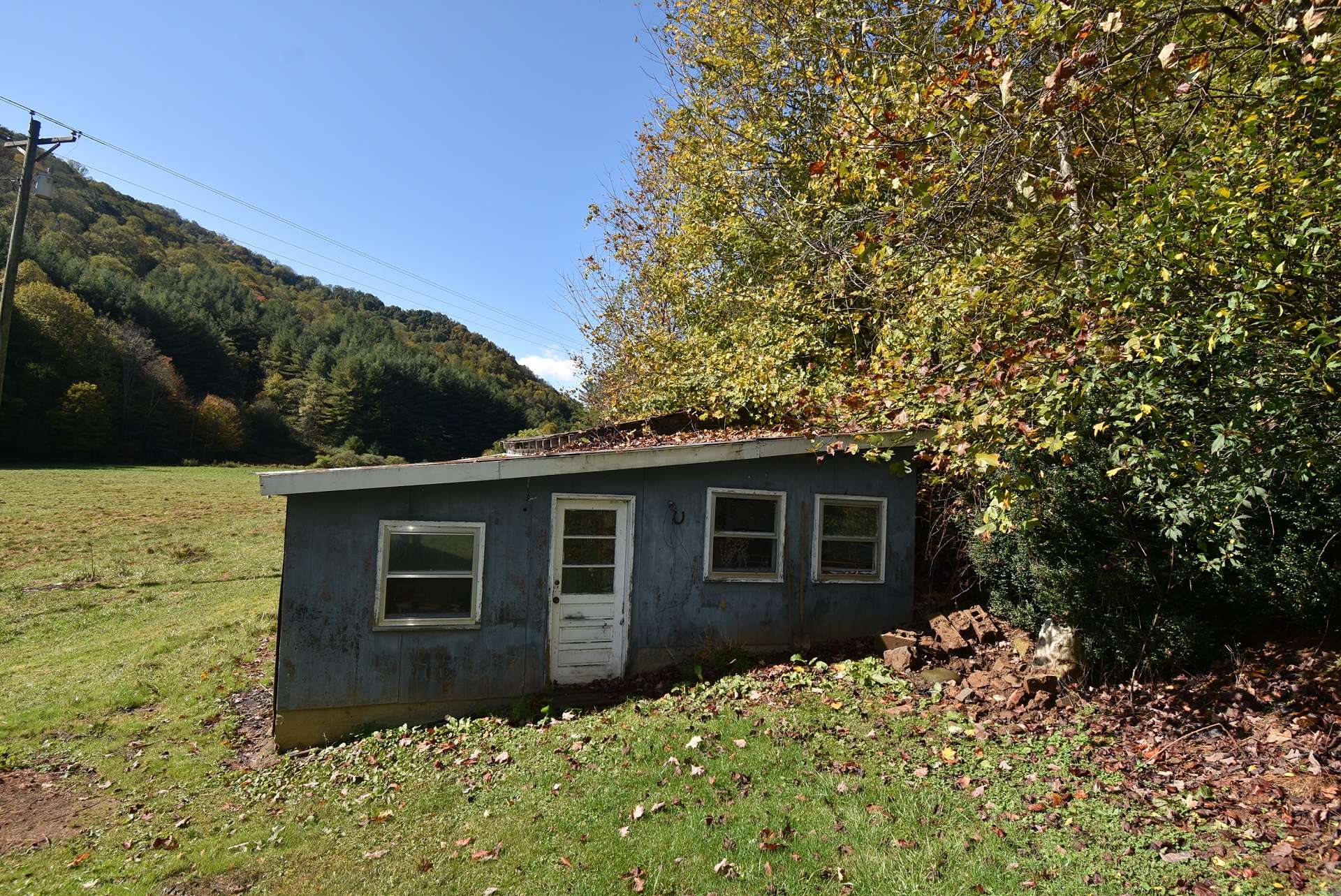 Other outbuildings provide storage space.