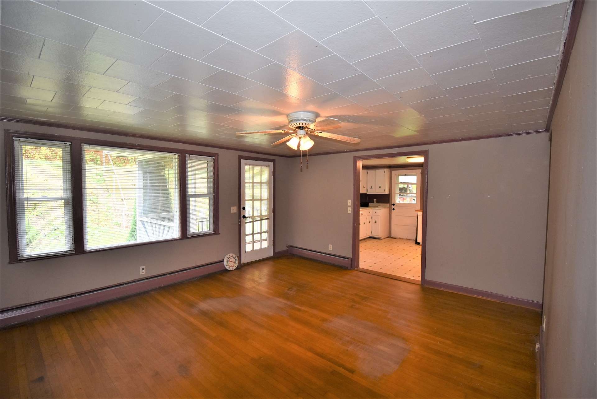 The living room features big windows and wood flooring. Plenty of room for the family to enjoy time together watching TV or sharing the events of the day.