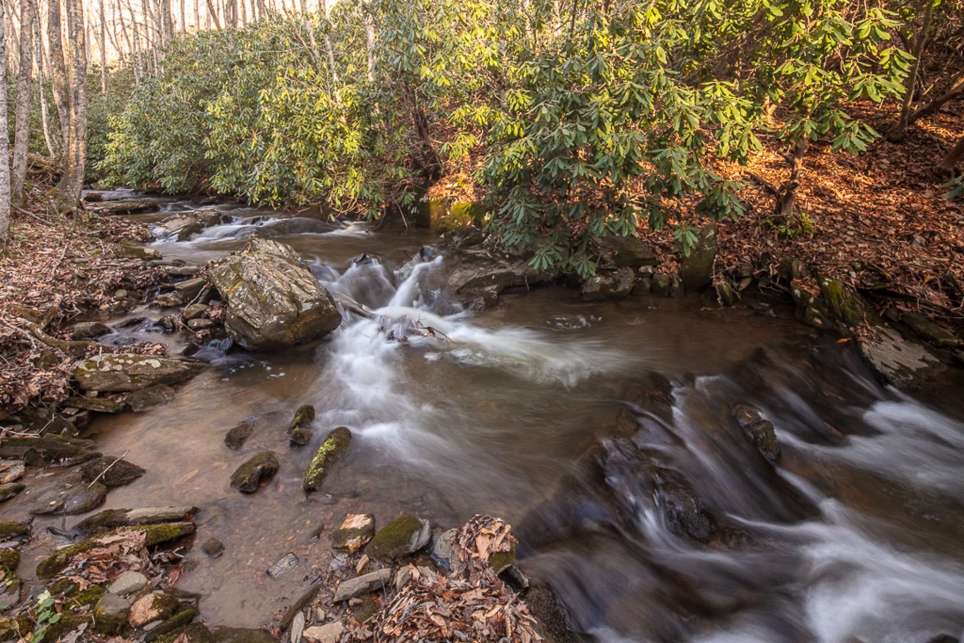 The 2.45 acre setting includes frontage on Little Elk Creek, which you can enjoy from the covered porches of the home.