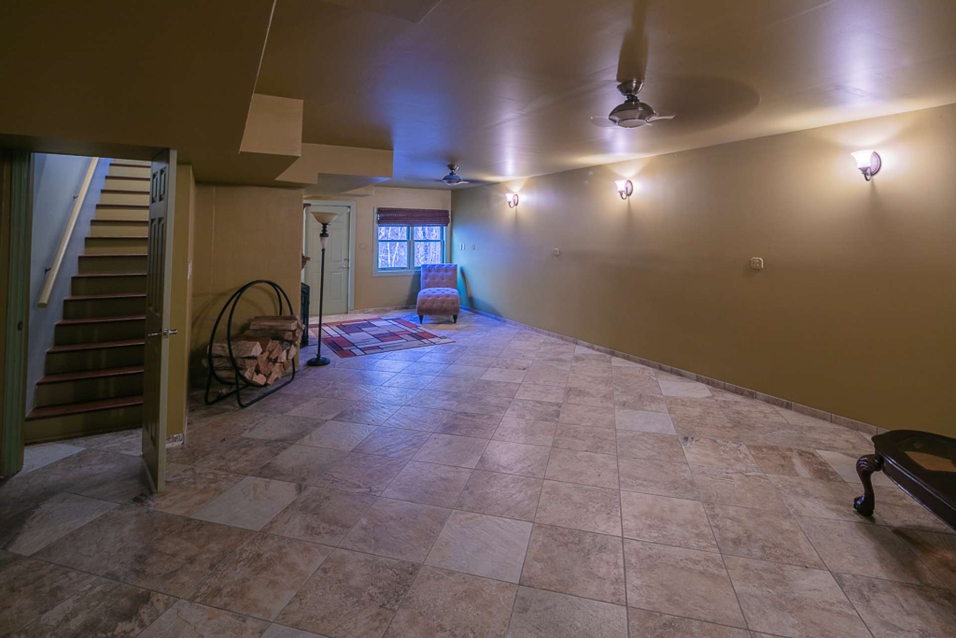 The lower level features a large open space, ideal for a game room, with fireplace and sitting area.