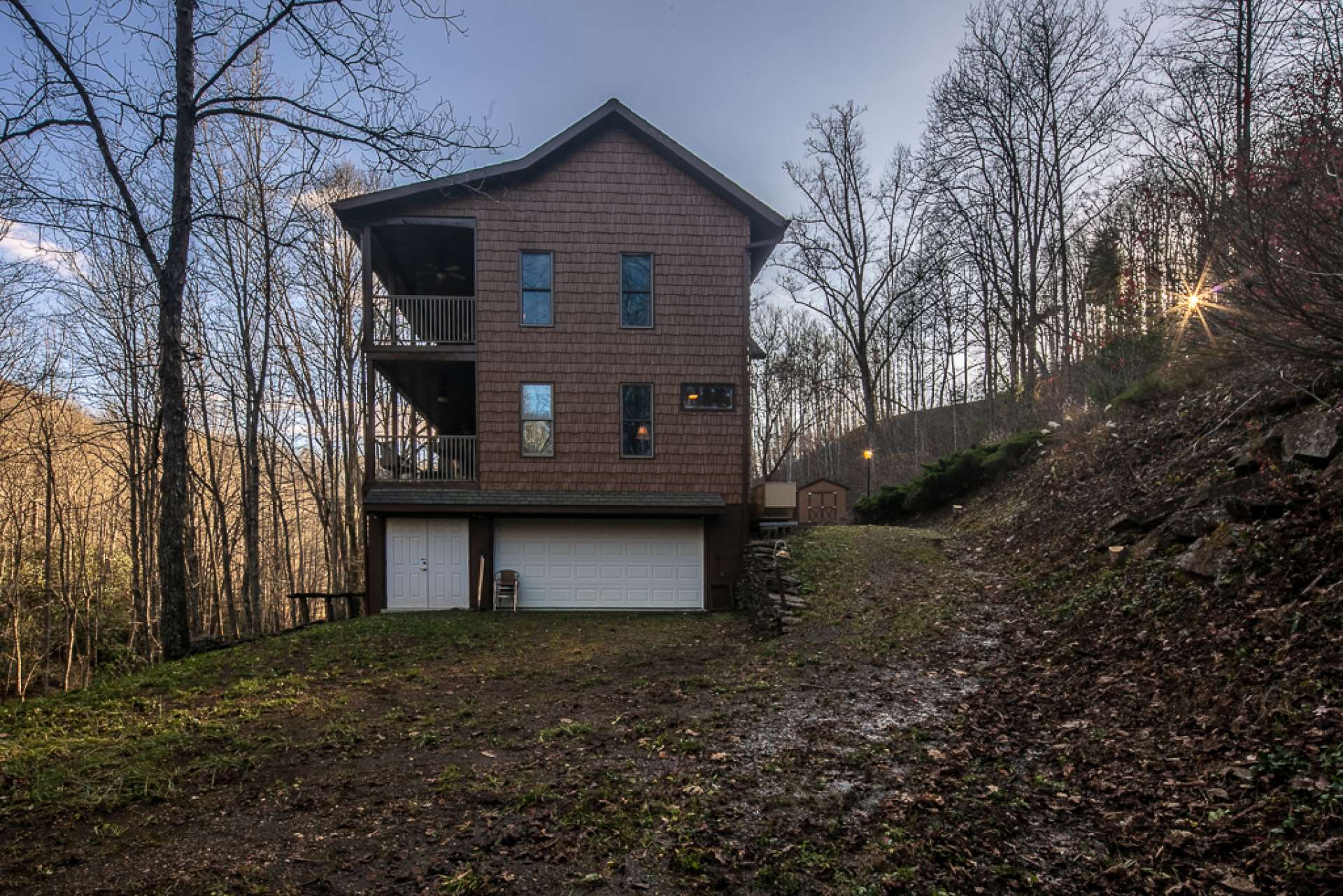 This view shows the side of the home with driveway access to the garage.