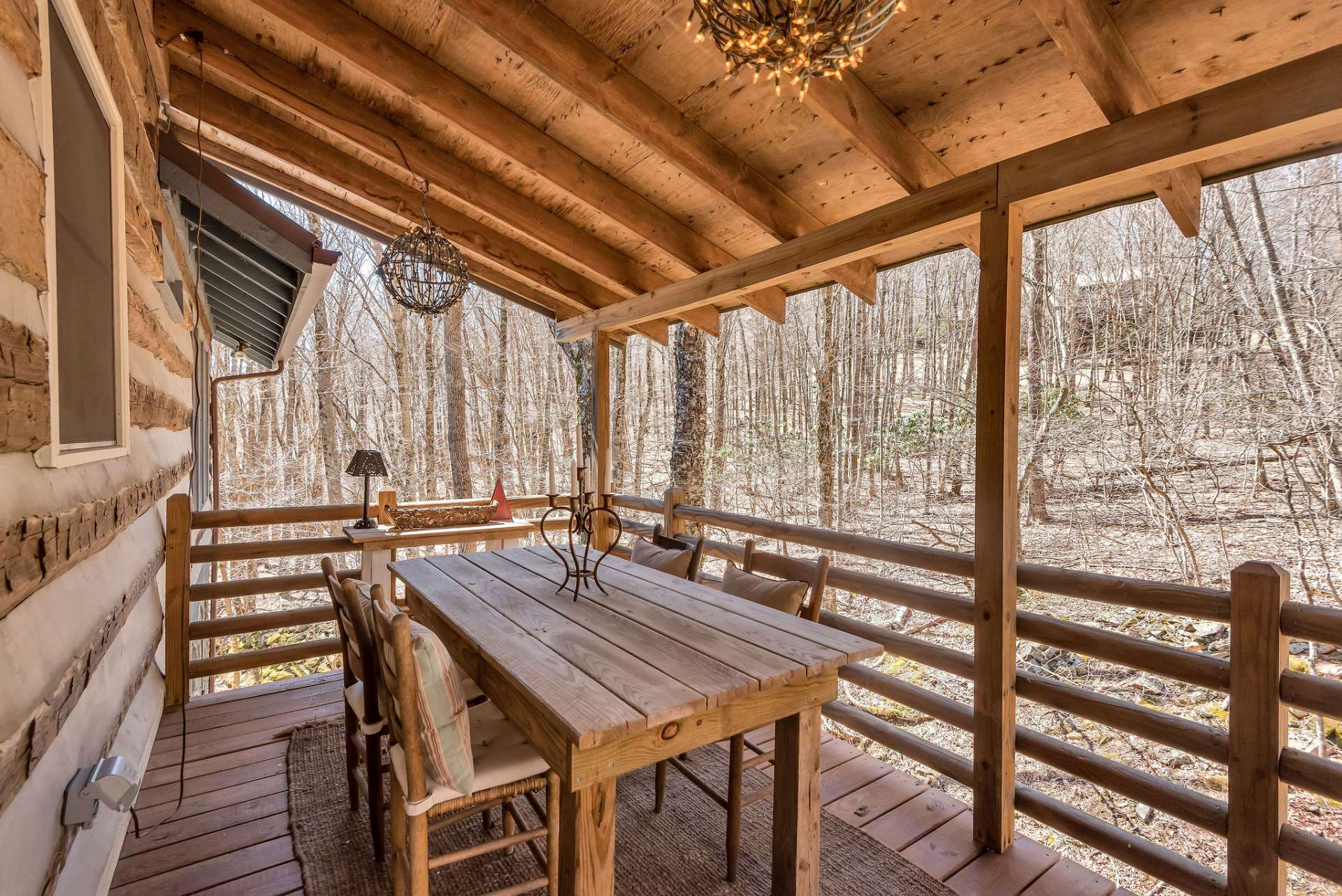 The covered back porch is the epitome of al fresco charm. Just imagine gathering with loved ones around a rustic table, savoring delicious meals while surrounded by nature's beauty.
