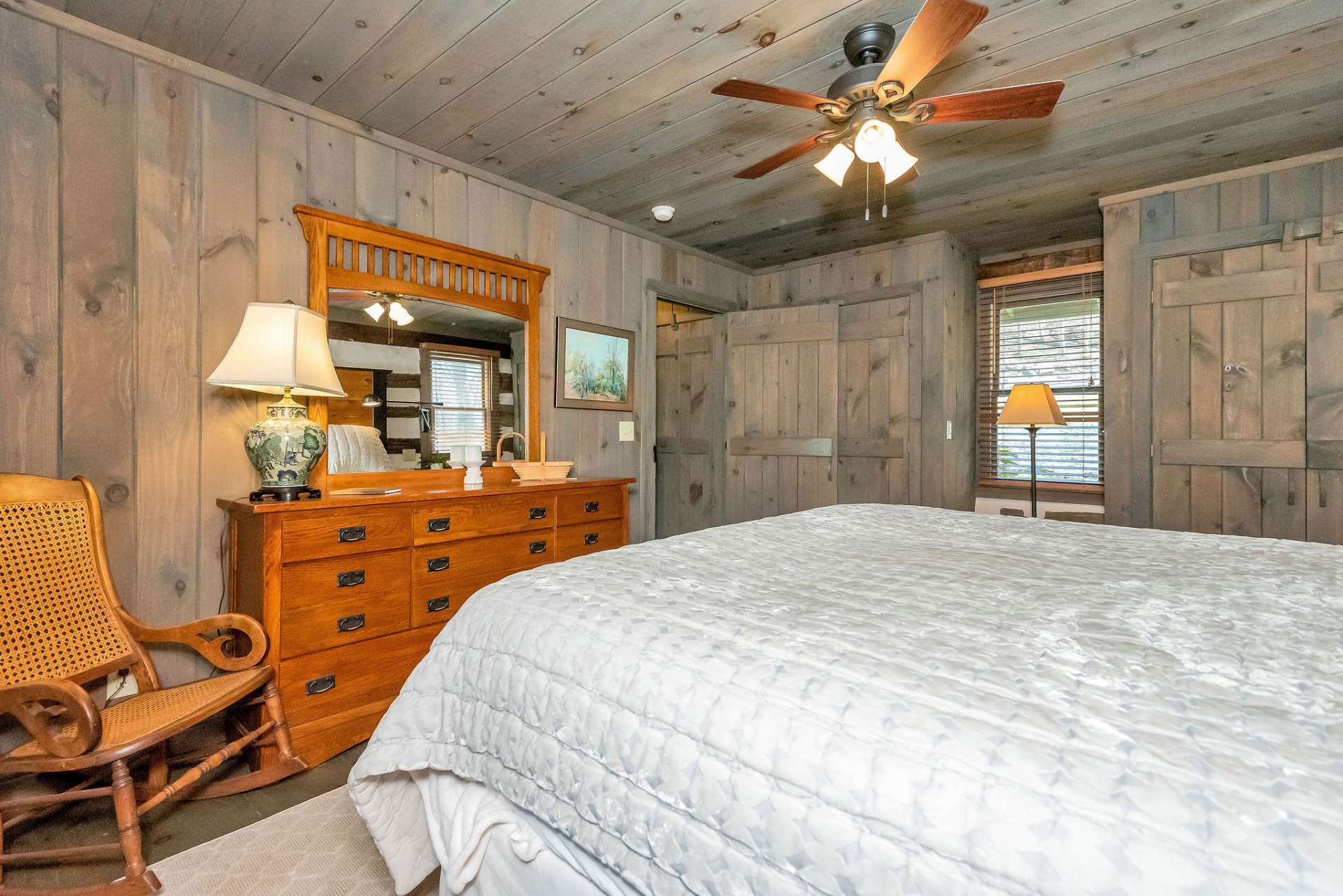 Designed with rustic charm and comfort in mind, the primary bedroom features warm wood, cozy furnishings, and soft textiles that create a welcoming and inviting atmosphere.