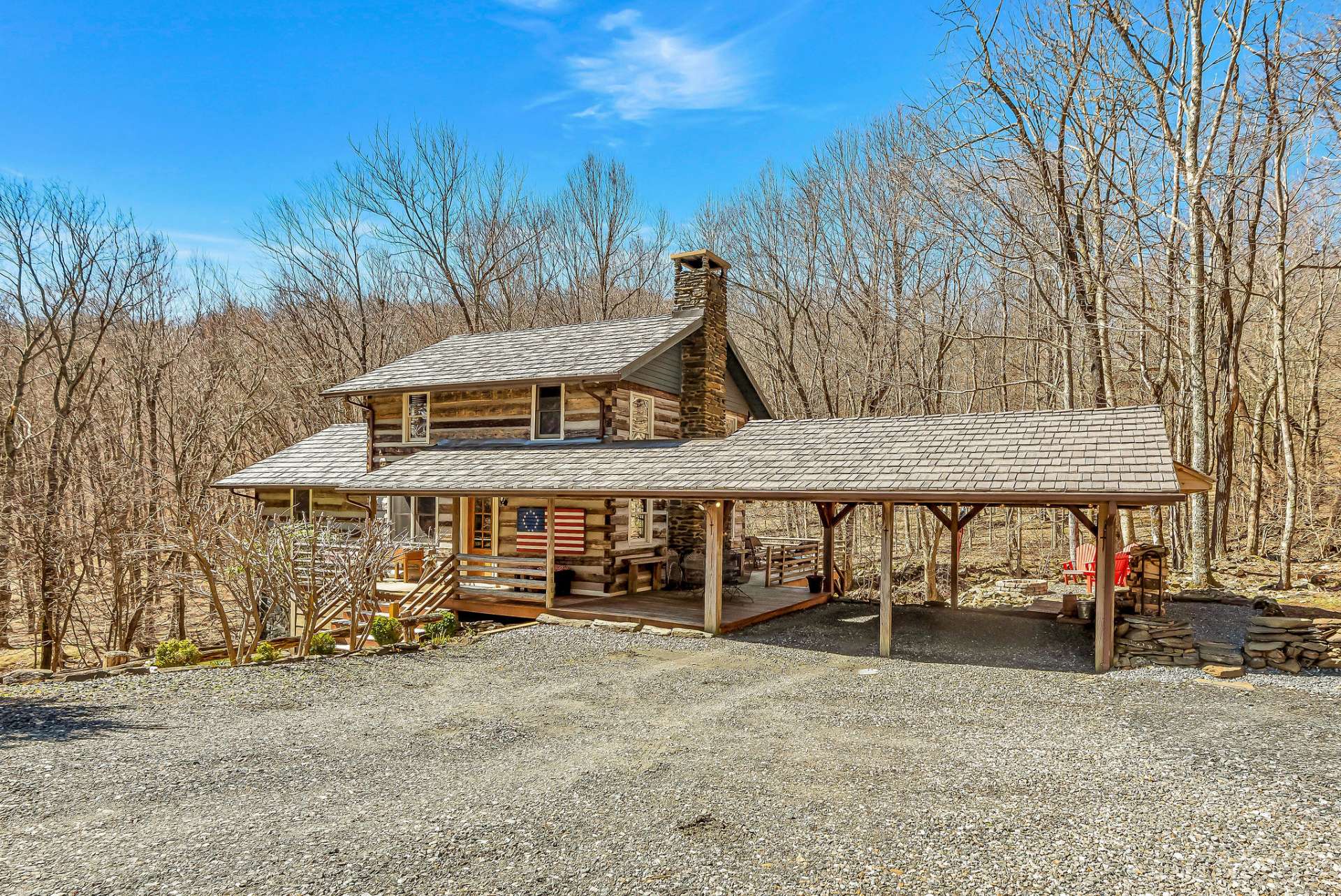 A 2-car attached carport offers convenient covered parking space for vehicles while also complementing the architectural design of the cabin.