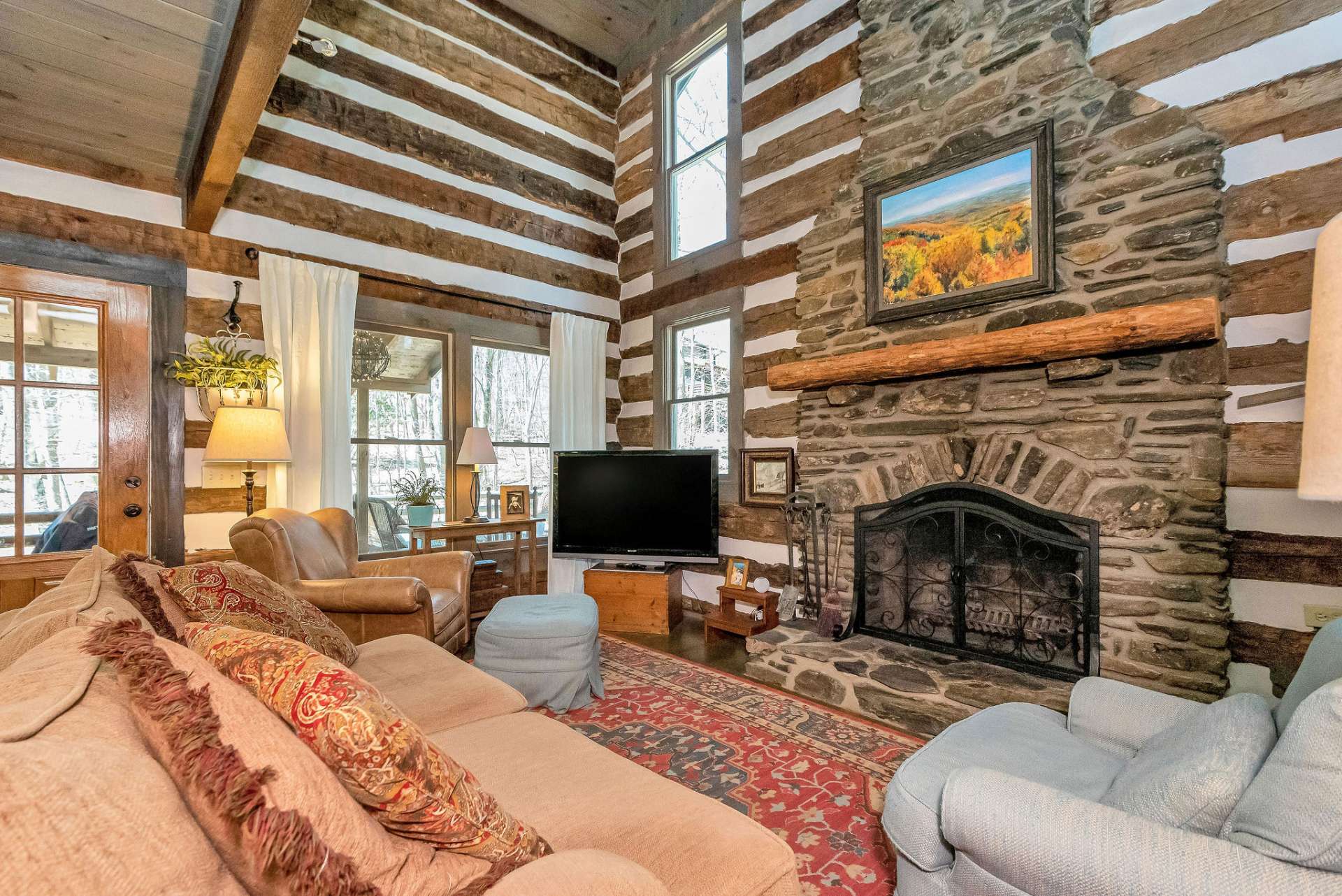 Step inside to discover an inviting open great room adorned with a floor-to-ceiling native stone fireplace.