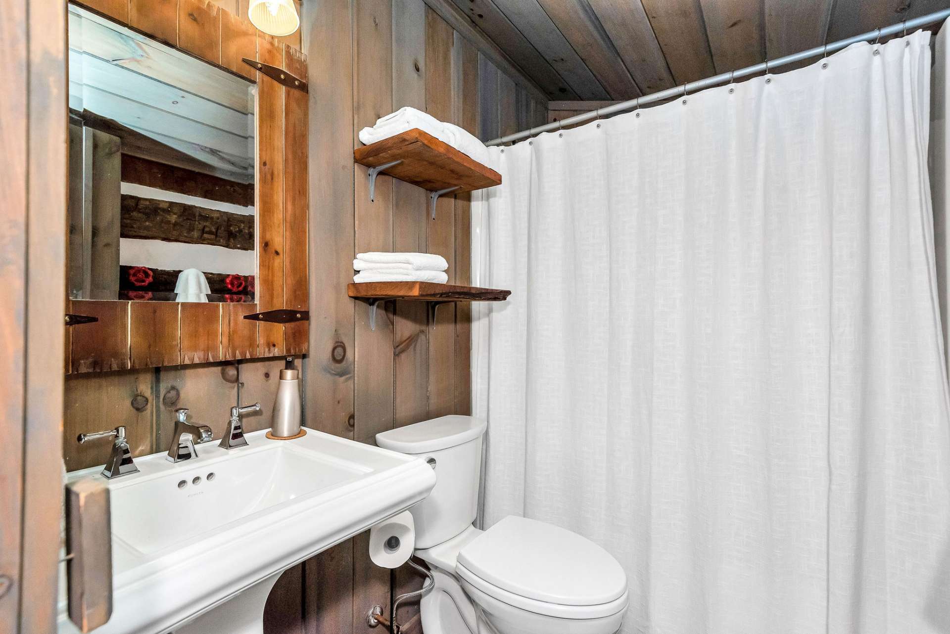 The full bath in the loft bedroom is a charming and functional space that offers convenience and comfort within the cozy confines of the cabin's upper level. The tub/shower combination provides versatility for occupants who prefer either a quick shower or a relaxing soak in the tub.