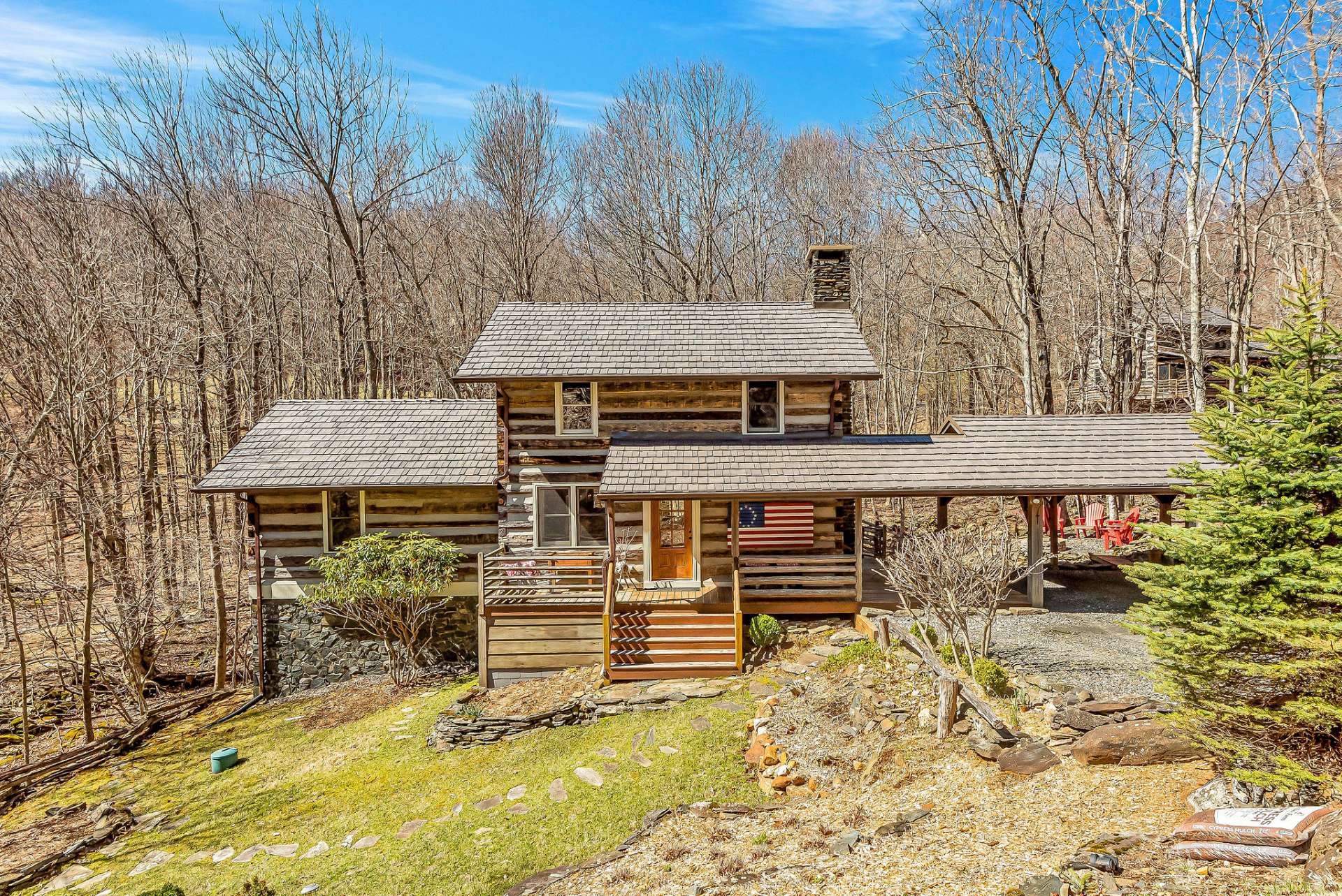 The exterior of the cabin exudes charm with its rustic facade blending seamlessly into the lush landscape.