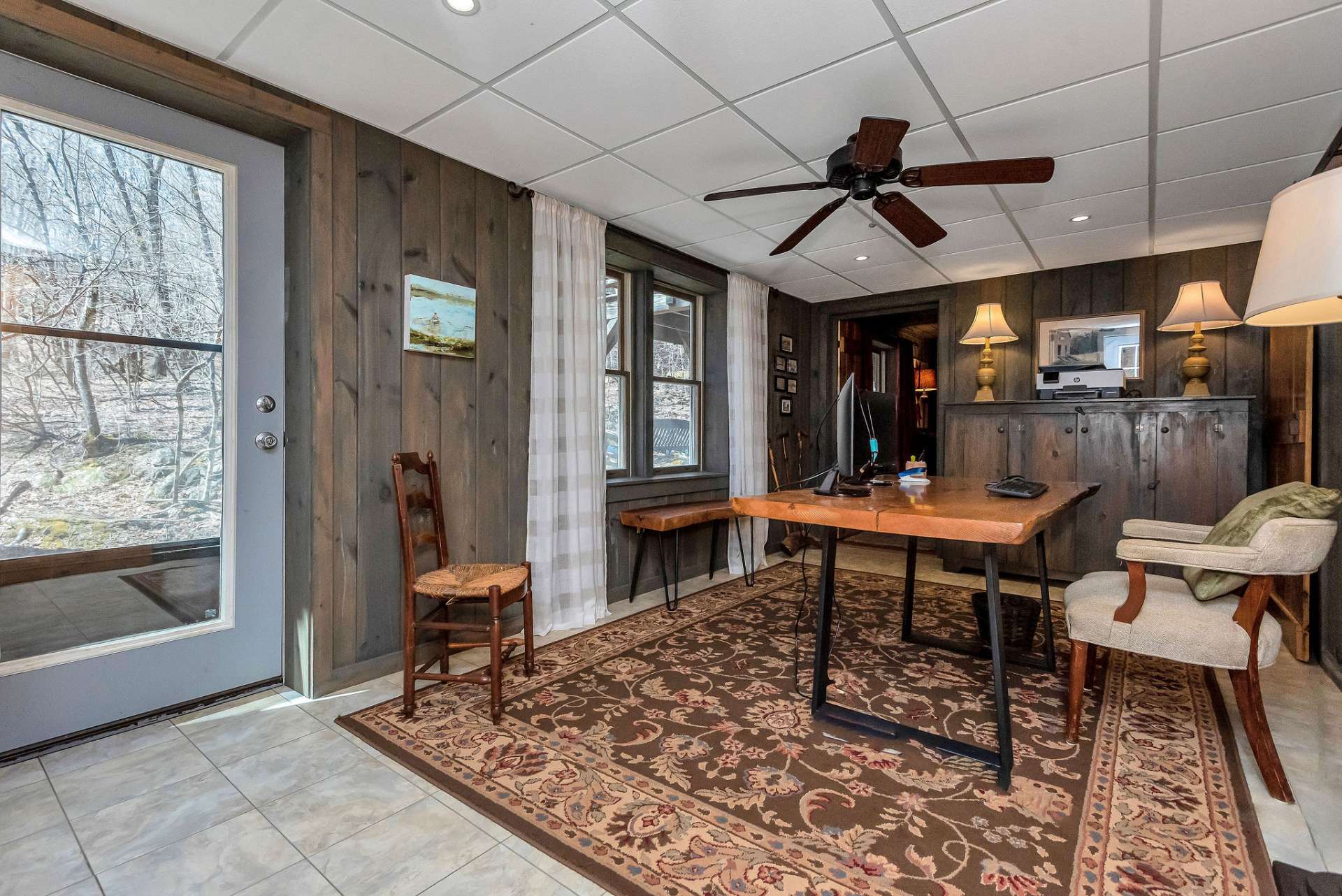 Two separate exterior doors in this area provide convenient access to the outdoor living areas surrounding the cabin, allowing occupants to seamlessly transition between indoor and outdoor spaces.