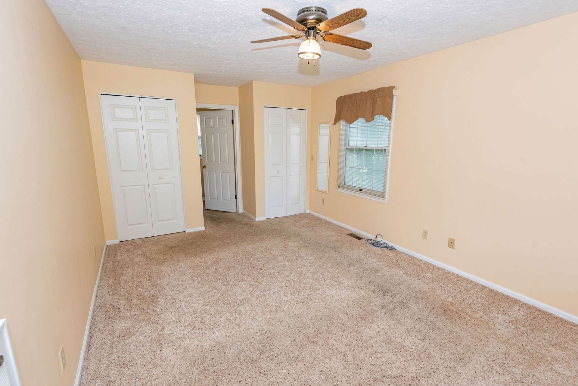 The nicely sized master suite is located on the main level and offers comfortable carpeted floor, two closets, and a private bath.