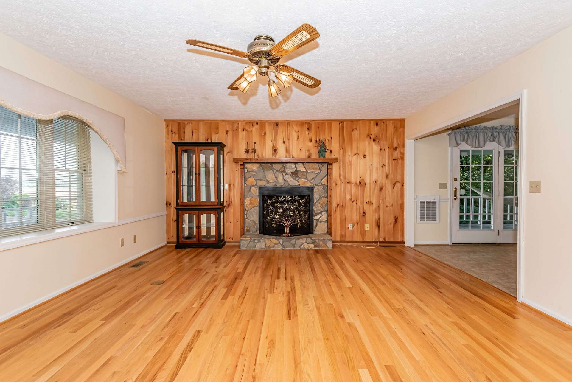 The main level offers a spacious  living area with wood floors and plenty of natural light.