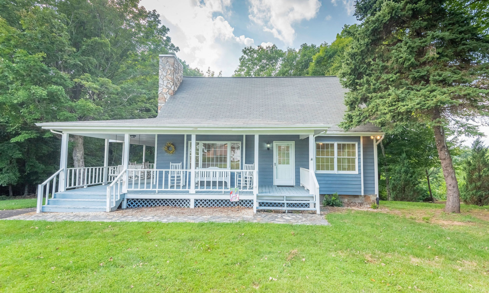 Country Cottage living in golf course style with this sweet NC Mountain home located on a peaceful setting in the Mountain Aire Golf Course community.