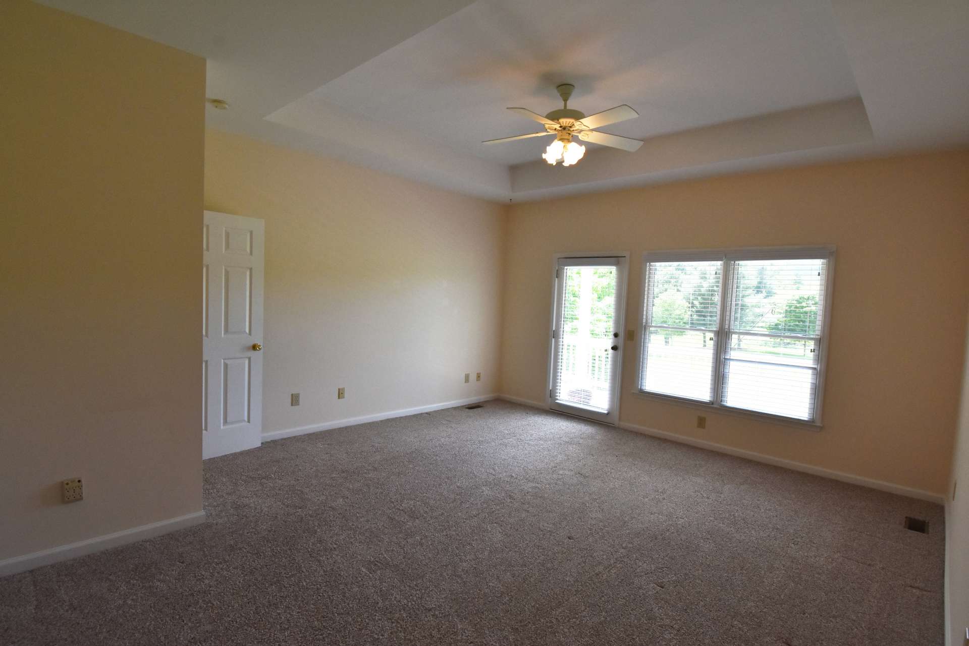 The main level master suite features a trey ceiling,  a private bath with jetted tub and separate shower, and private access to the porch where you can enjoy the views.