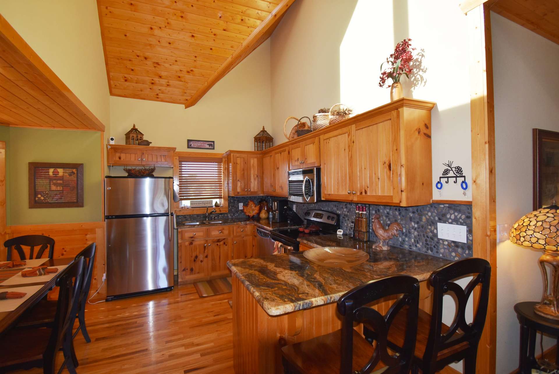The kitchen is sure to please any chef with its stainless appliances, custom cabinetry with granite counter tops, and plenty of work and storage space including a bar with seating.