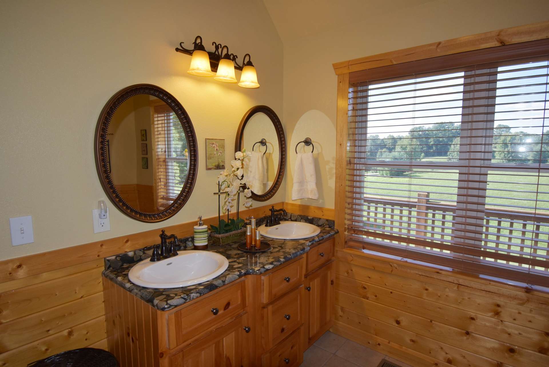 Notice the unique and interesting granite countertop on the double vanity in the master bath.