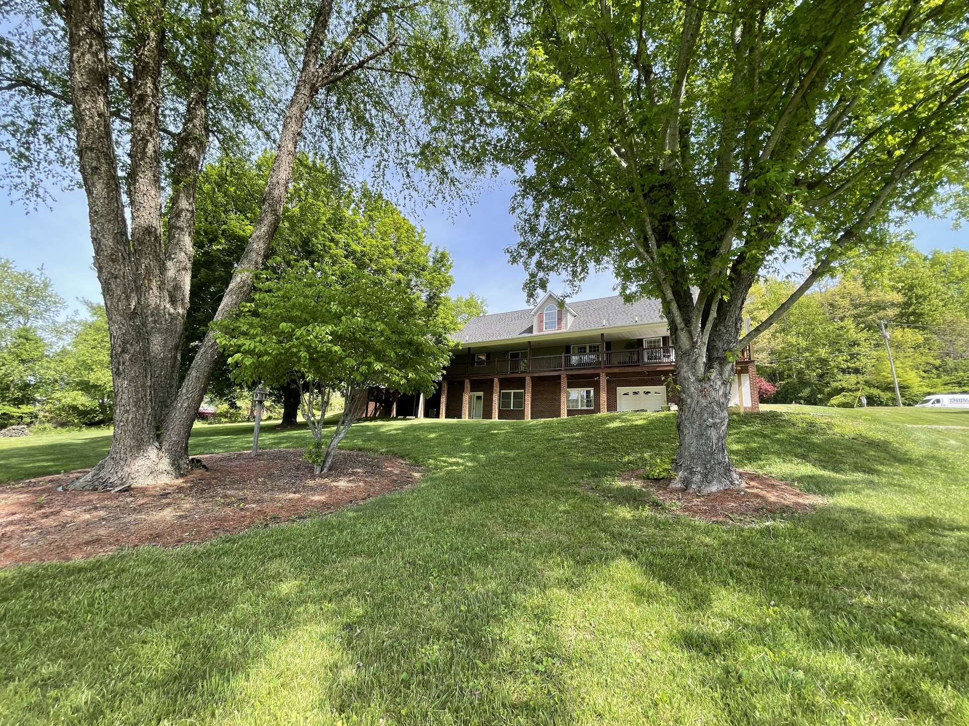 The 1.12-acre setting offers a beautifully manicured lawn for gardening or play.