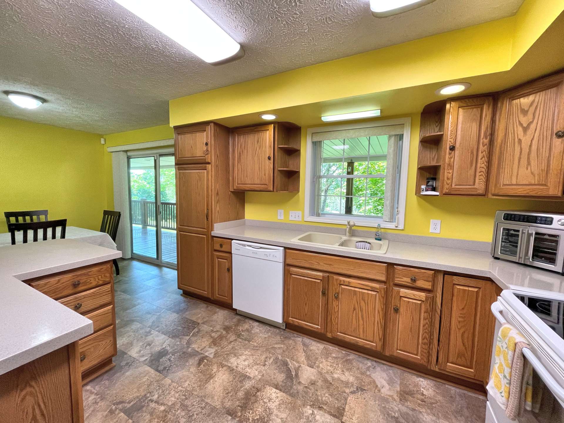 Kitchen and dining area opens to the back deck for outdoor grilling and dining.