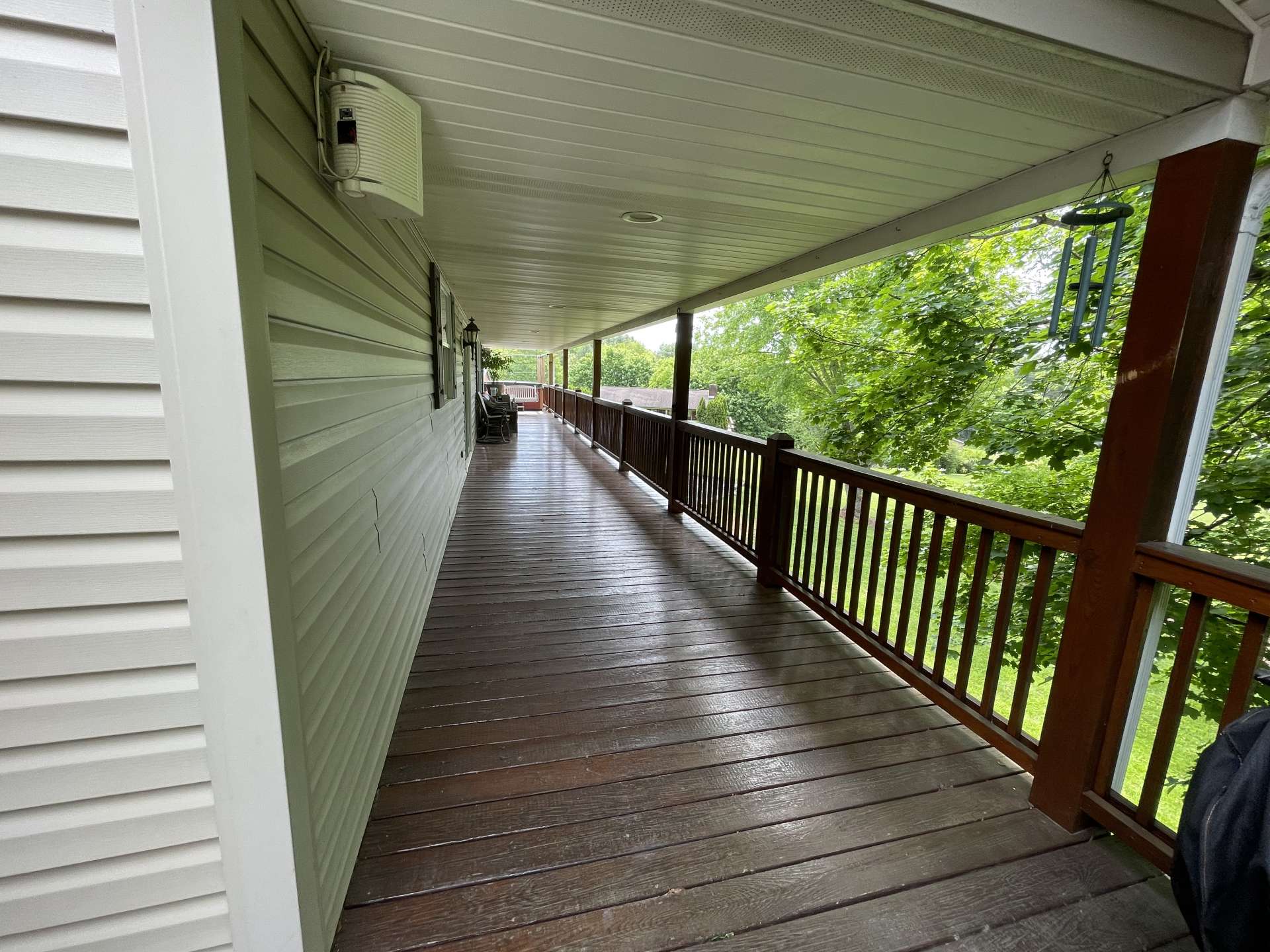 The covered back deck is ideal for outdoor entertaining or just enjoying the gorgeous backyard.