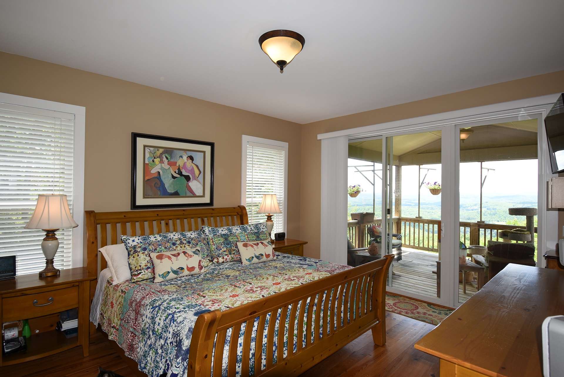 The master bedroom is located on the main level and features a private bath and access to the partially covered back deck where layered long-range mountain views brighten even the darkest of days.