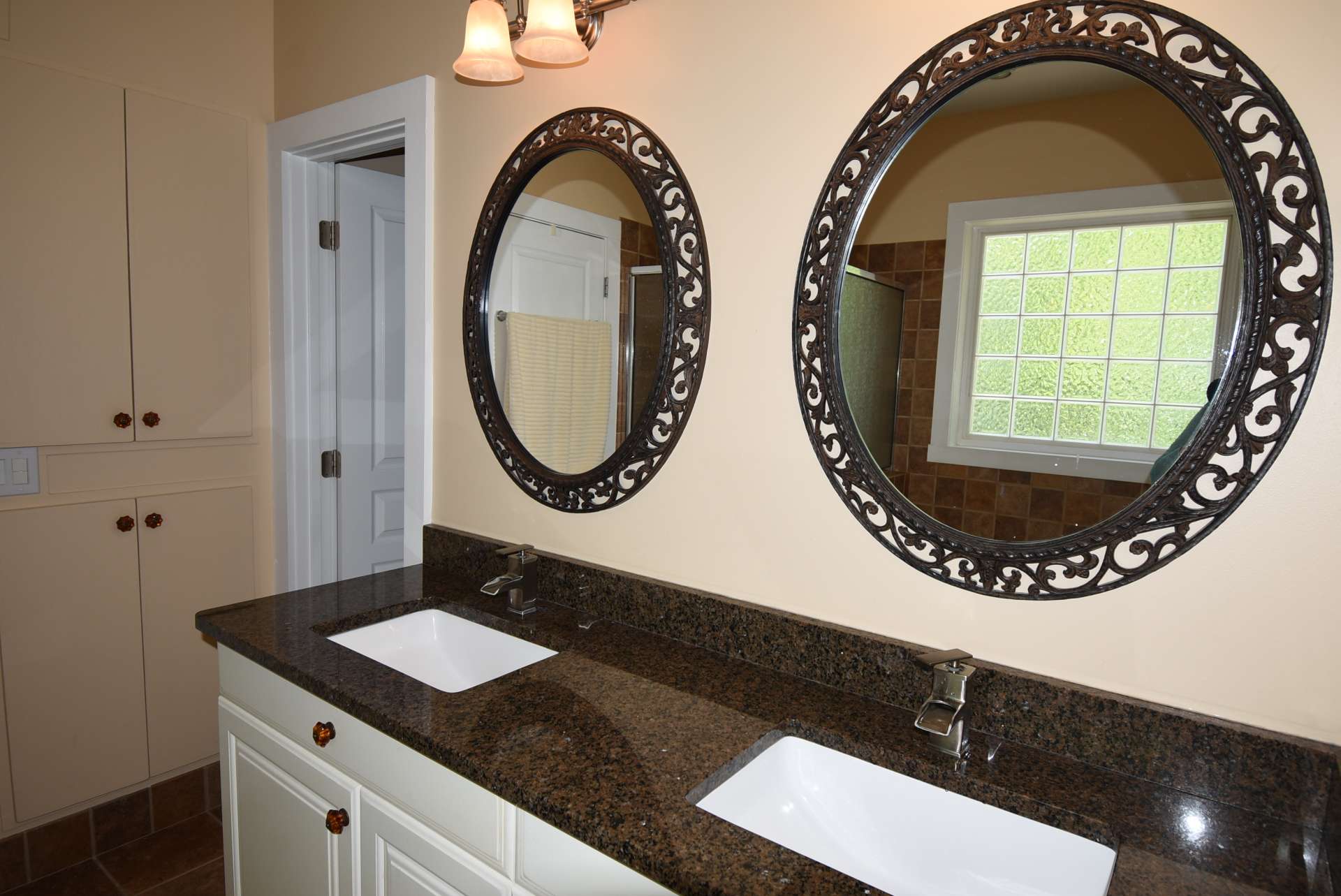 The private master bath offers a luxurious retreat. Features include a double vanity with granite counter, garden tub, and separate walk-in shower.