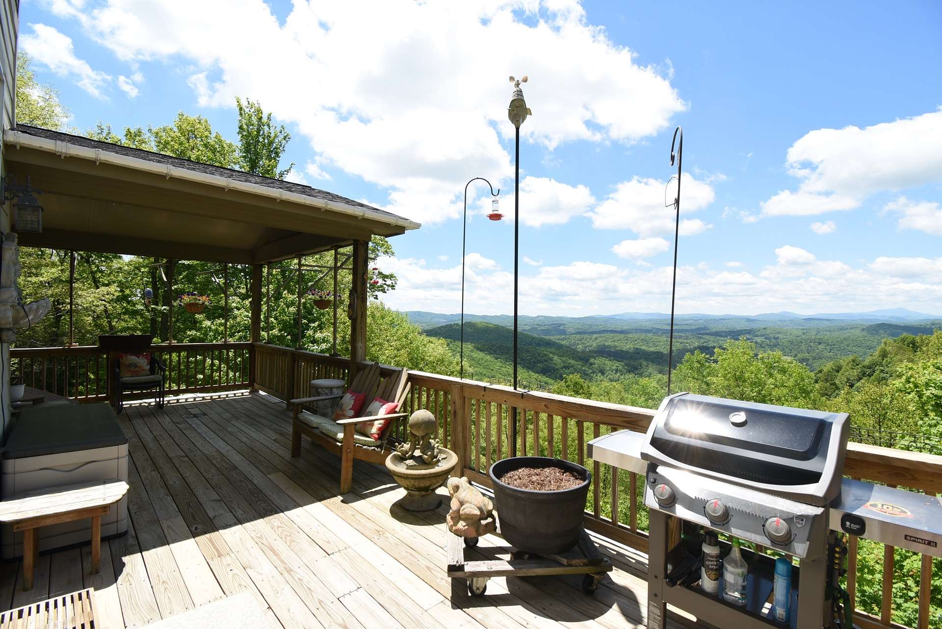 Tremendous long-range views of Grandfather Mountain and distant ski slopes await you here on the partially covered back deck.
